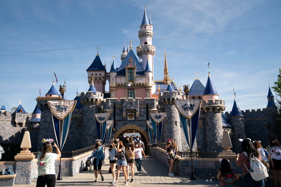 FILE - Visitors pass through Disneyland in Anaheim, Calif., April 30, 2021. (AP Photo/Jae C. Hong, File)