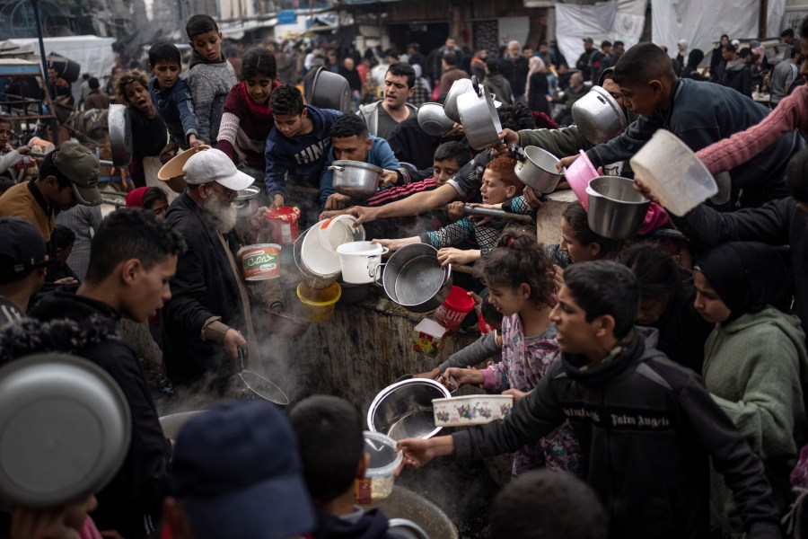 FILE - Palestinians line up for a meal in Rafah, Gaza Strip, Thursday, Dec. 21, 2023. The United Nations appealed for $2.8 billion on Tuesday, April 17, 2024, to provide desperately needed aid to 3 million Palestinians, stressing that tackling looming famine in war-torn Gaza requires not only food but sanitation, water and health facilities. (AP Photo/Fatima Shbair, File)