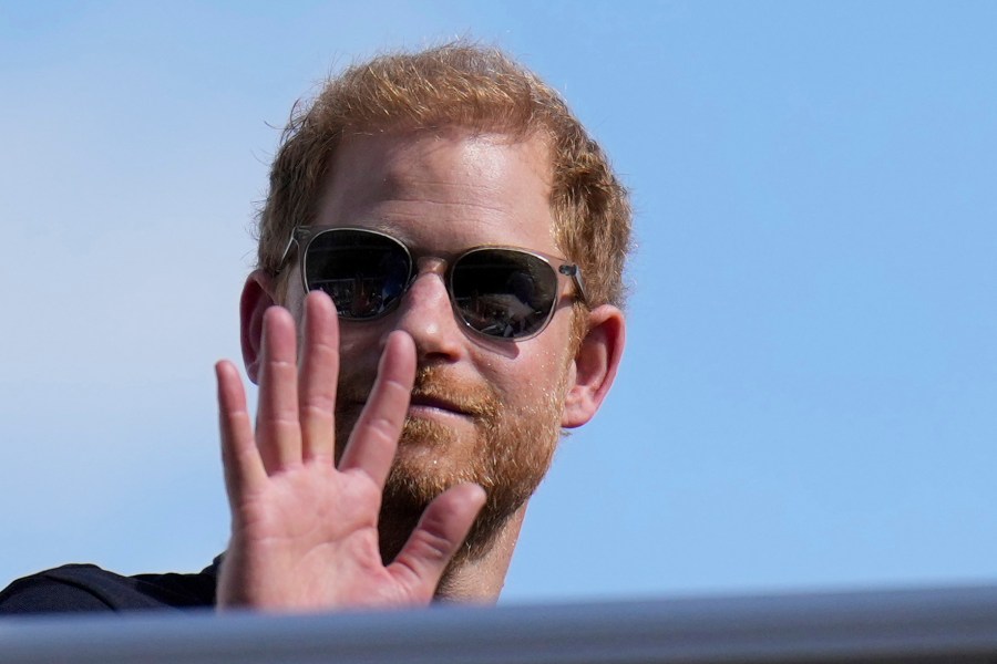 FILE - Britain's Prince Harry, the Duke of Sussex, waves during the Formula One U.S. Grand Prix auto race at Circuit of the Americas, on Oct. 22, 2023, in Austin, Texas. Prince Harry, the son of King Charles III and fifth in line to the British throne, has formally confirmed his is now a U.S. resident. Four years after Harry and his American wife, Meghan, decamped to a villa on the Southern California coast, a travel company he controls filed paperwork informing British authorities that he has moved and is now “usually resident” in the United States. (AP Photo/Nick Didlick, File)