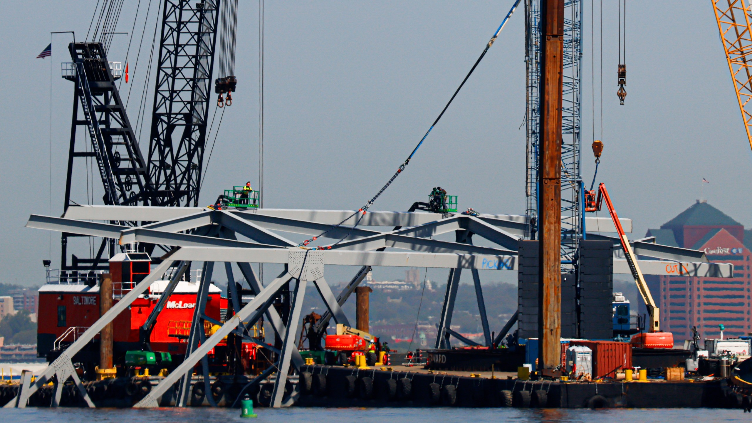 Salvage work continues on the collapsed Francis Scott Key Bridge, Monday, April 15, 2024, in Baltimore. The FBI confirmed that agents were aboard the Dali conducting court-authorized law enforcement activity. (AP Photo/Julia Nikhinson)