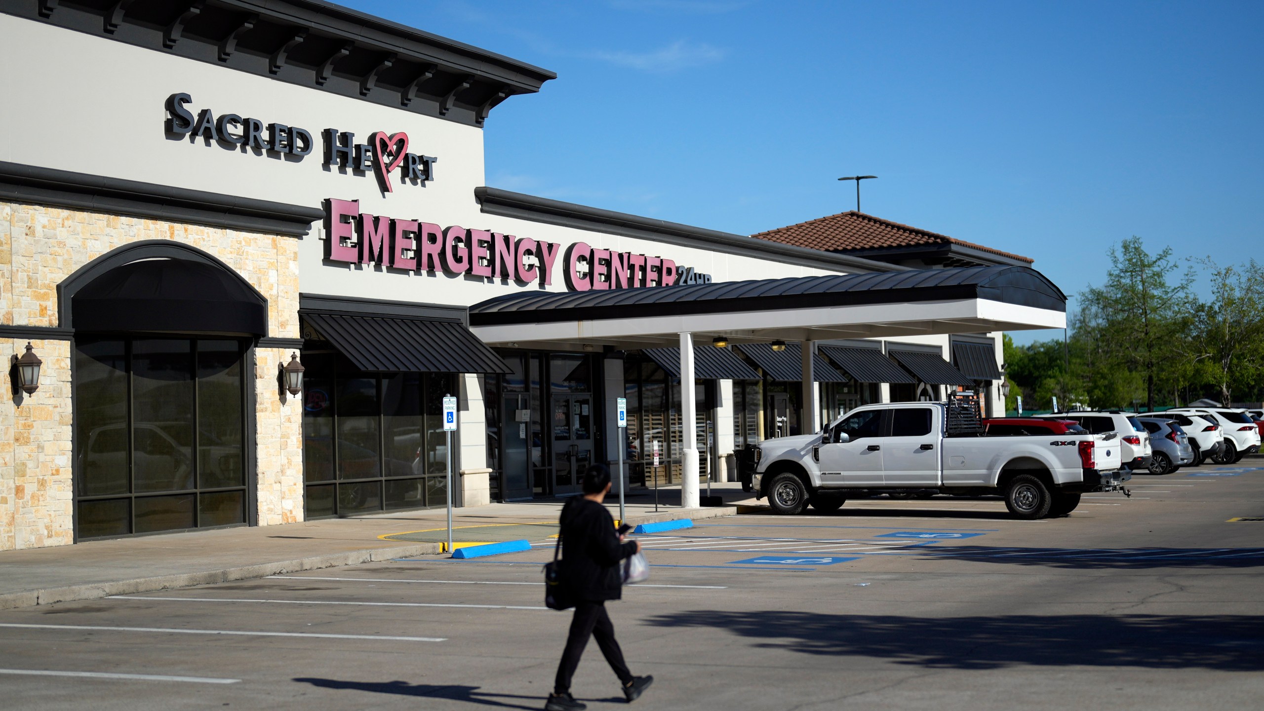 Sacred Heart Emergency Center is pictured Friday, March 29, 2024, in Houston. Complaints about pregnant women being turned away from emergency rooms spiked in the months after states began enacting strict abortion laws following the 2022 U.S. Supreme Court decision overturning Roe v. Wade. At Sacred Heart Emergency Center in Houston, front desk staff refused to check-in one woman after her husband asked for help delivering her baby. She miscarried in a restroom toilet in the emergency room lobby while her husband called 911 for help. (AP Photo/David J. Phillip)