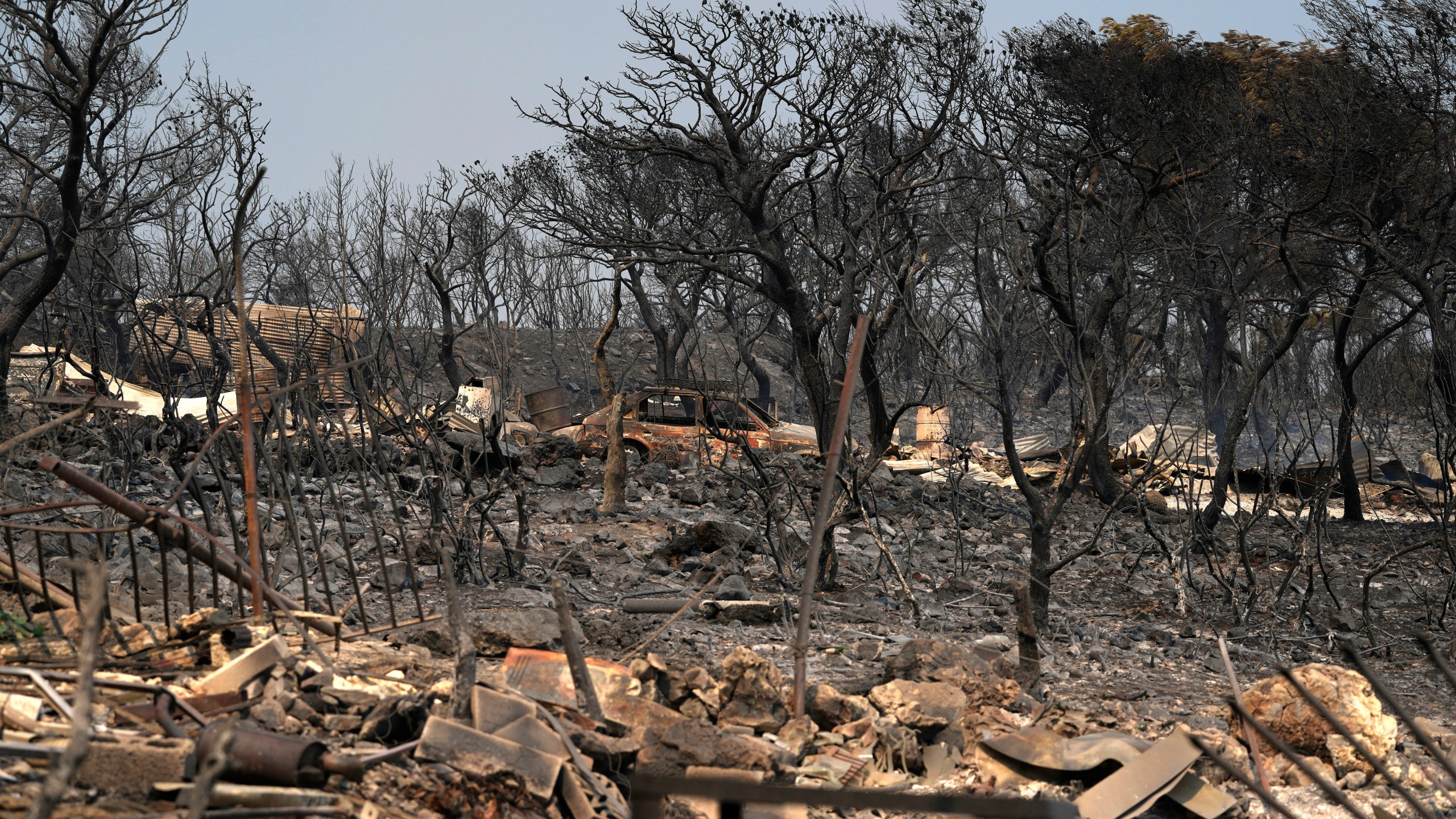 FILE - Burnt trees and a car after yesterday's fire in Mandra, west of Athens, on Wednesday, July 19, 2023. Europe is the fastest-warming continent and its temperatures are rising at roughly twice the global average, two top climate monitoring organizations reported Monday, April 22, 2024, warning of the consequences for human health, glacier melt and economic activity. (AP Photo/Thanassis Stavrakis, File)