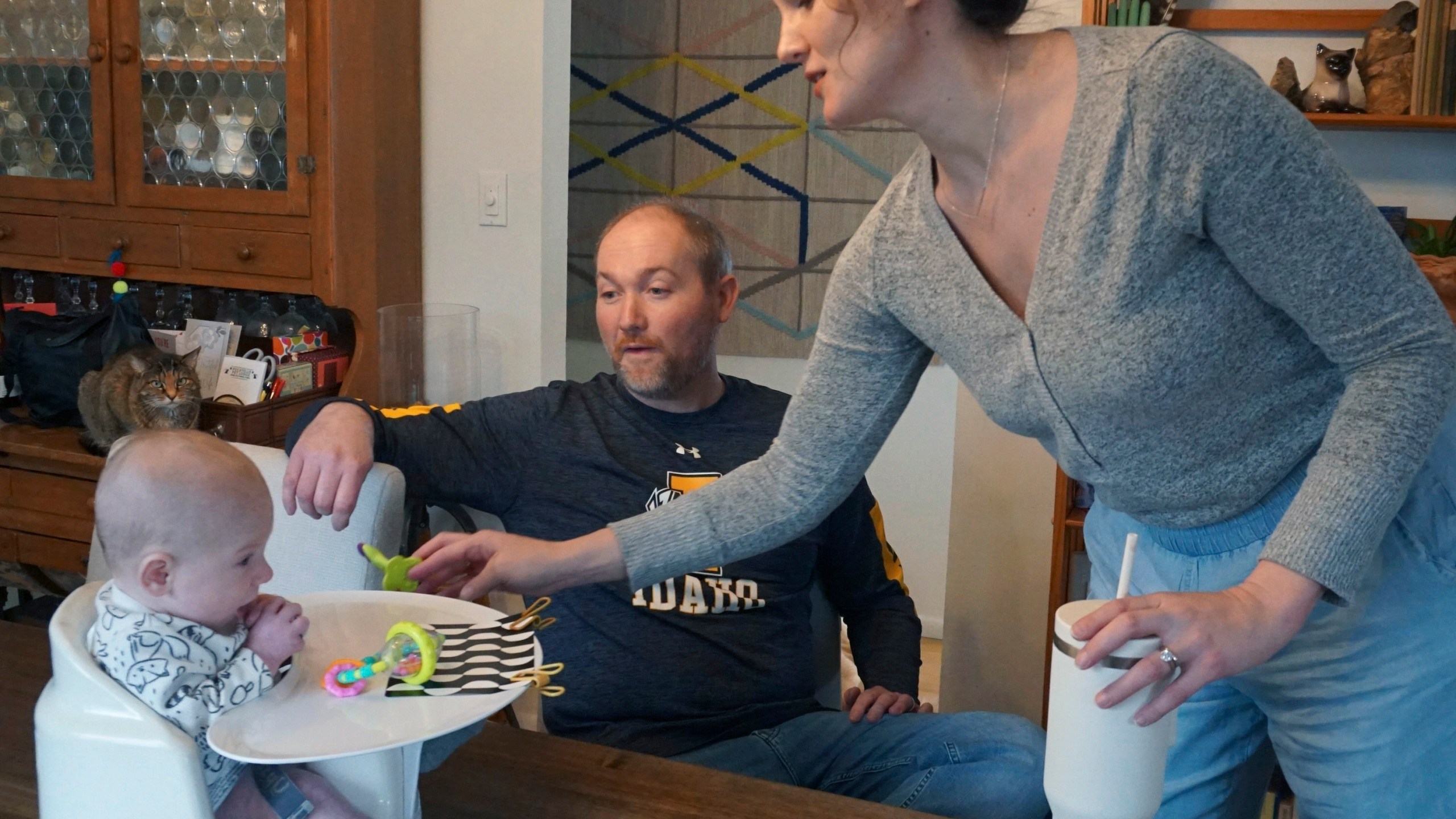 Mike and Jane Roberts tend to their son, Dennis, at their Pocatello, Idaho, home on Friday, March 1, 2024. When Jane Roberts gave birth in November, she and her husband, both teachers, quickly realized sending baby Dennis to day care was out of the question. It was too costly, and they worried about finding a quality provider in their hometown of Pocatello, Idaho.(Carly Flandro/Idaho Education News via AP)