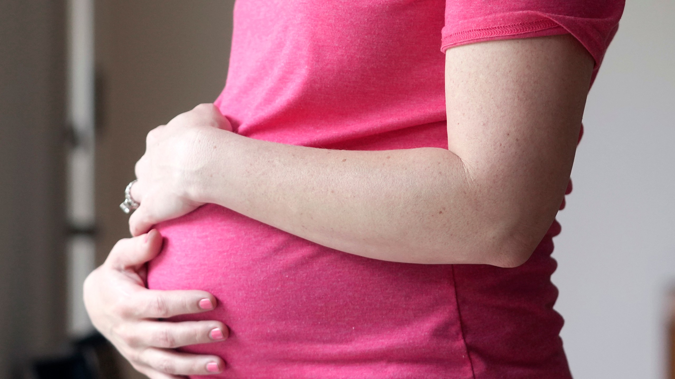 FILE - A pregnant woman stands for a portrait in Dallas, Thursday, May 18, 2023. According to provisional statistics for 2023 released by the Centers for Disease Control and Prevention on Thursday, April 25, 2024, U.S. births fell last year, in a substantial drop marking an apparent end to pandemic-related fluctuations and a return to a long-standing national decline. A little under 3.6 million babies were born in the U.S. last year, about 76,000 fewer than the year before. (AP Photo/LM Otero, File)