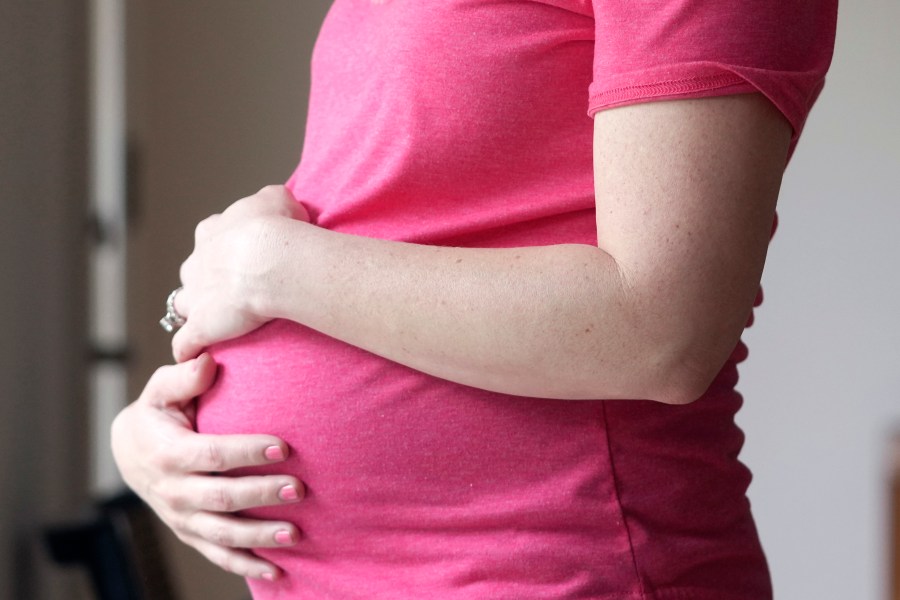 FILE - A pregnant woman stands for a portrait in Dallas, Thursday, May 18, 2023. According to provisional statistics for 2023 released by the Centers for Disease Control and Prevention on Thursday, April 25, 2024, U.S. births fell last year, in a substantial drop marking an apparent end to pandemic-related fluctuations and a return to a long-standing national decline. A little under 3.6 million babies were born in the U.S. last year, about 76,000 fewer than the year before. (AP Photo/LM Otero, File)