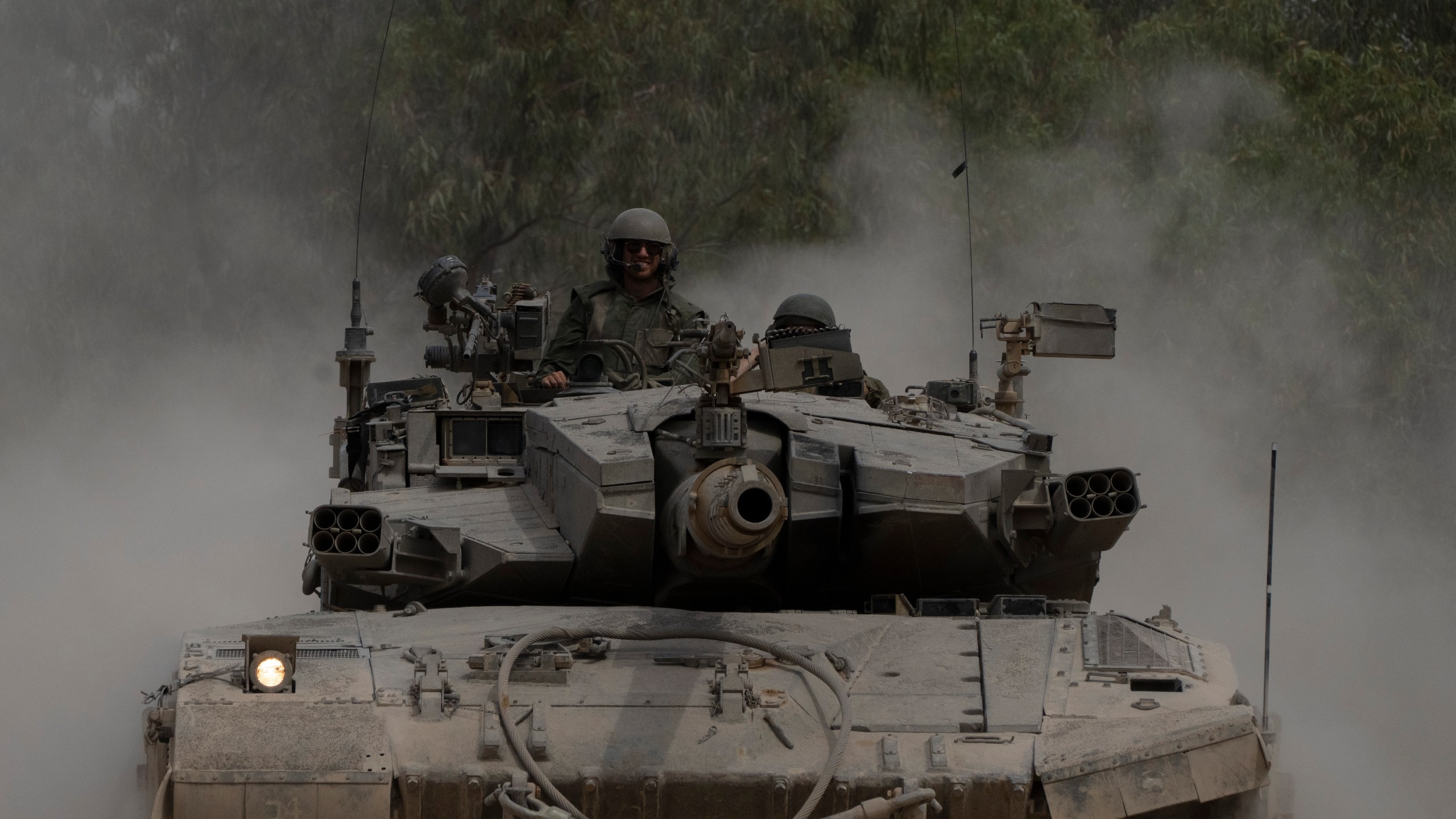 Israeli soldiers move on the top of a tank near the Israeli-Gaza border, as seen from southern Israel, Thursday, April 25, 2024. (AP Photo/Leo Correa)