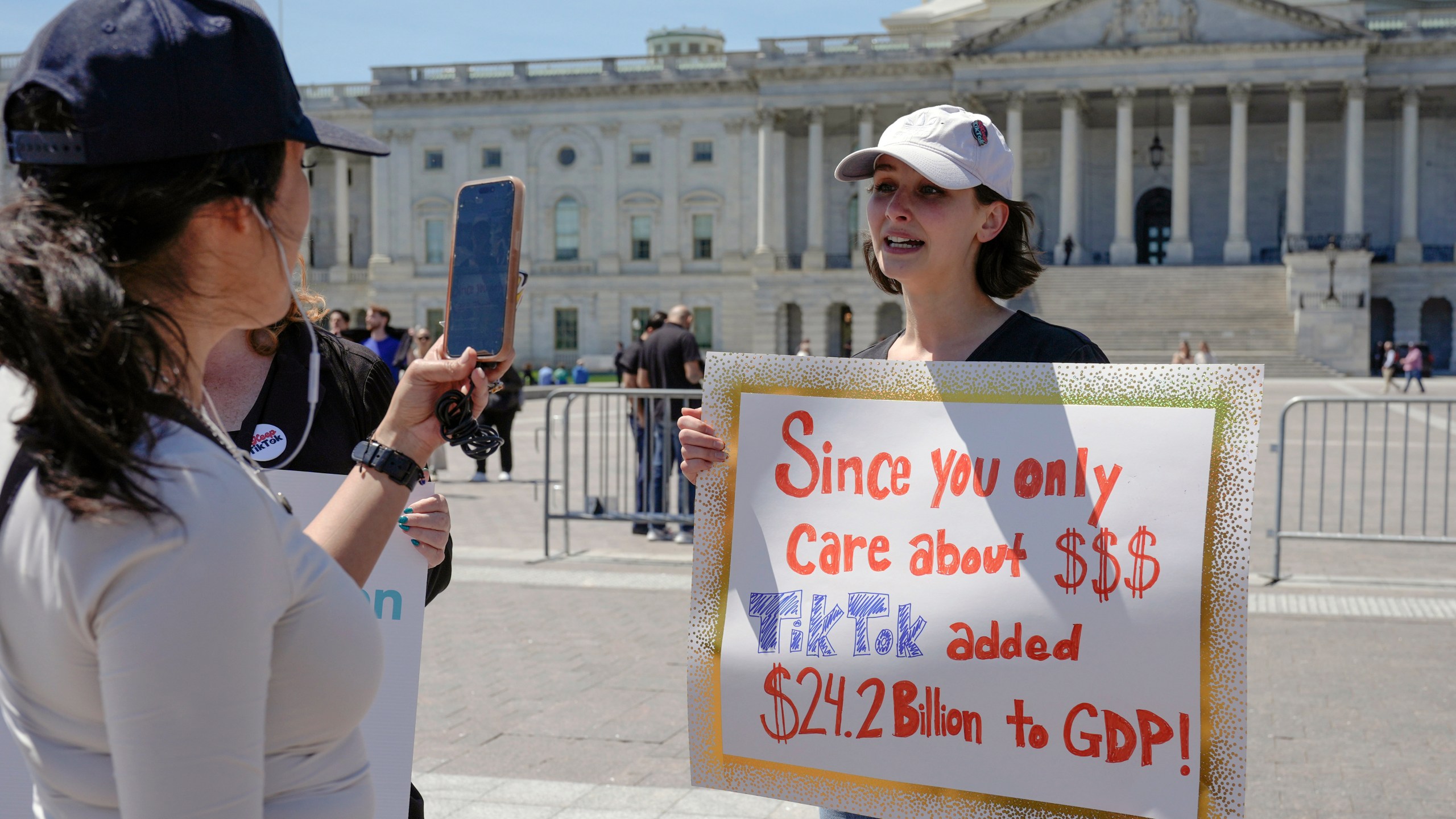 A TikTok content creator, speaks to reporters outside the U.S. Capitol, Tuesday, April 23, 2024, in Washington, as Senators prepare to consider legislation that would force TikTok's China-based parent company to sell the social media platform under the threat of a ban, a contentious move by U.S. lawmakers. (AP Photo/Mariam Zuhaib)