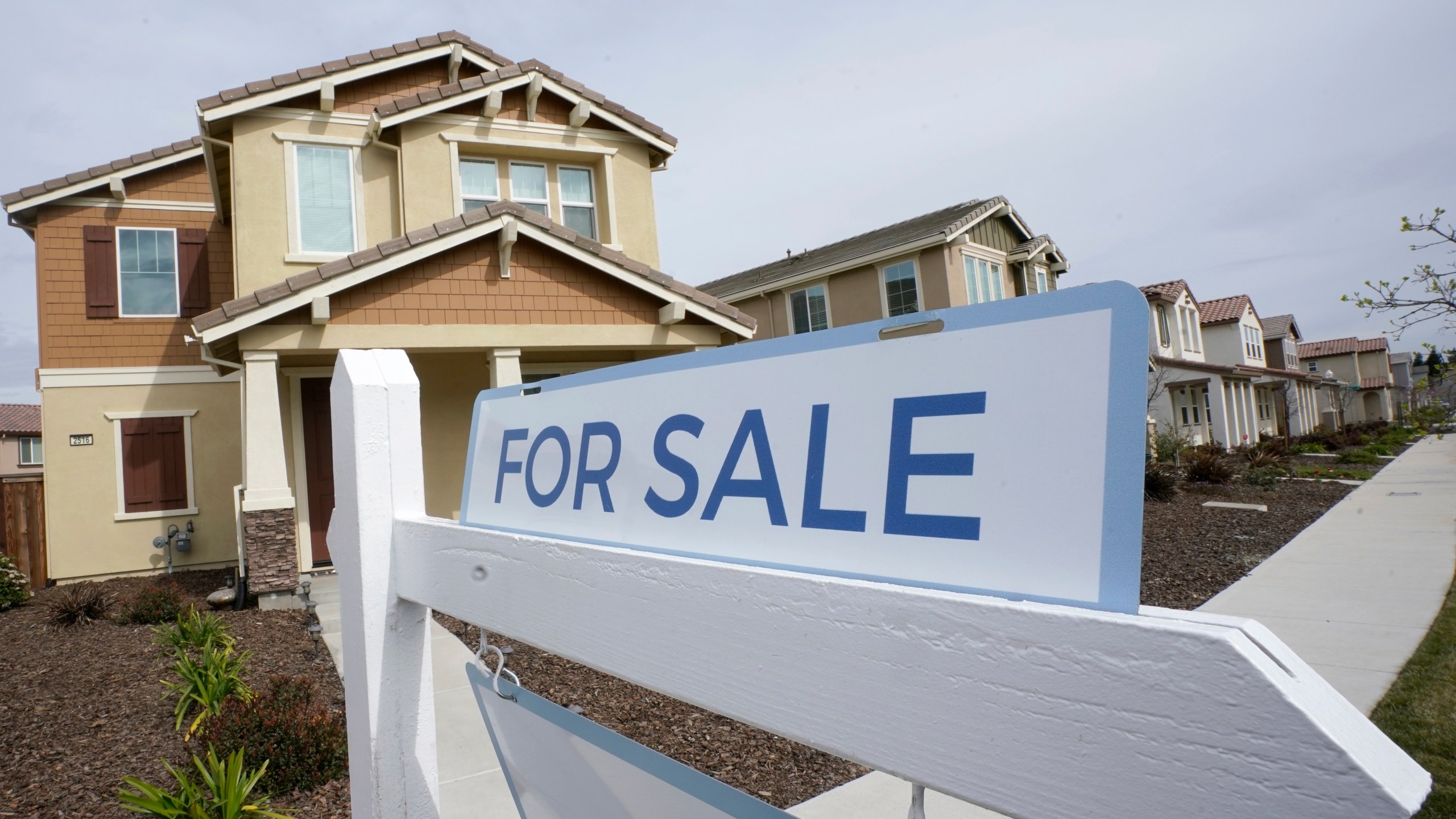 FILE - A for sale sign is posted in front of a home in Sacramento, Calif., Thursday, March 3, 2022. HomeServices of America, a real estate company owned by Warren Buffett’s Berkshire Hathaway, has agreed to pay $250 million to settle lawsuits nationwide claiming that longstanding practices by real estate brokerages forced U.S. homeowners to pay artificially inflated broker commissions when they sold their homes. (AP Photo/Rich Pedroncelli, File)