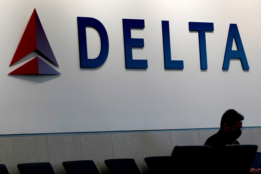 A man waits for a Delta Air Lines flight at Hartsfield-Jackson International Airport in Atlanta, Jan. 7, 2022.