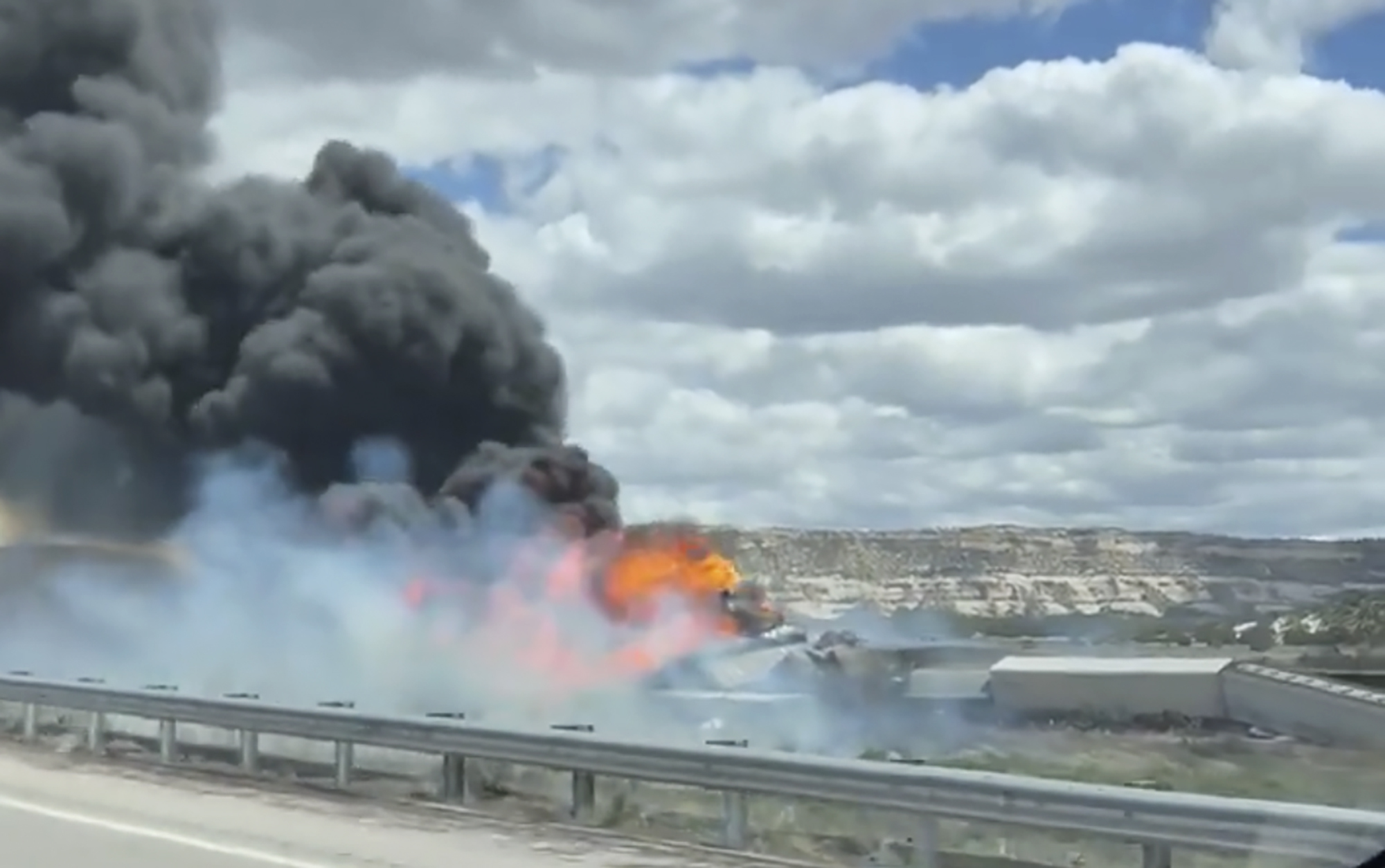 This frame grab taken from video provided by Bryan Wilson, shows a freight train carrying fuel that derailed and caught fire, Friday, April 26, 2024, near the New Mexico-Arizona state line, east of Lupton, Ariz. Authorities closed Interstate 40 in both directions in the area, directing trucks and motorists to alternate routes. (Bryan Wilson via AP)