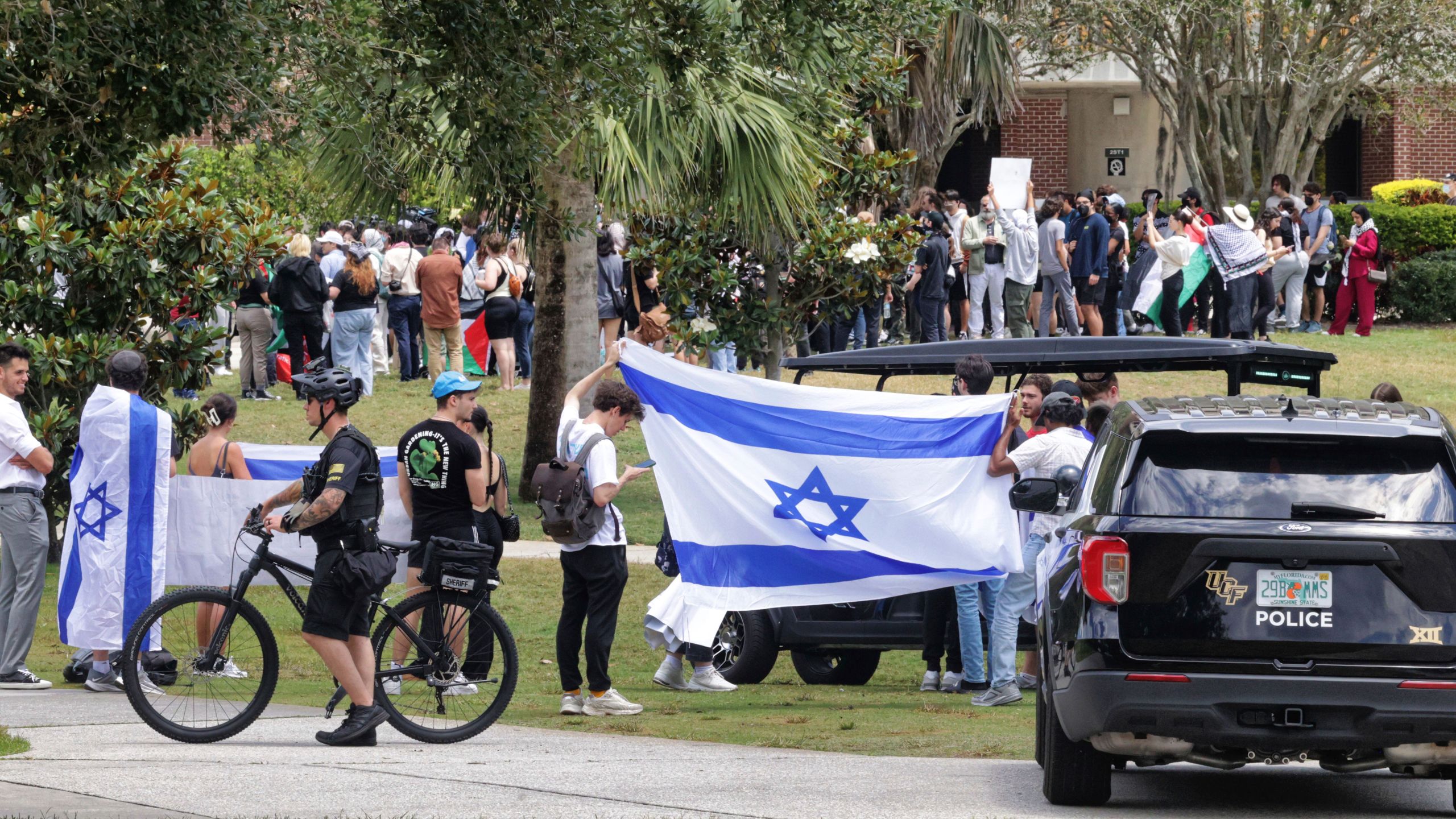 Counter-demonstrators supporting Israel march near a Pro-Palestinian protest at the University of Central Florida, in Orlando, Fla., Friday, April 26, 2024. Pro-Palestine protesters were estimated at about 200, with the Israel group being less than a dozen. (Joe Burbank/Orlando Sentinel via AP)