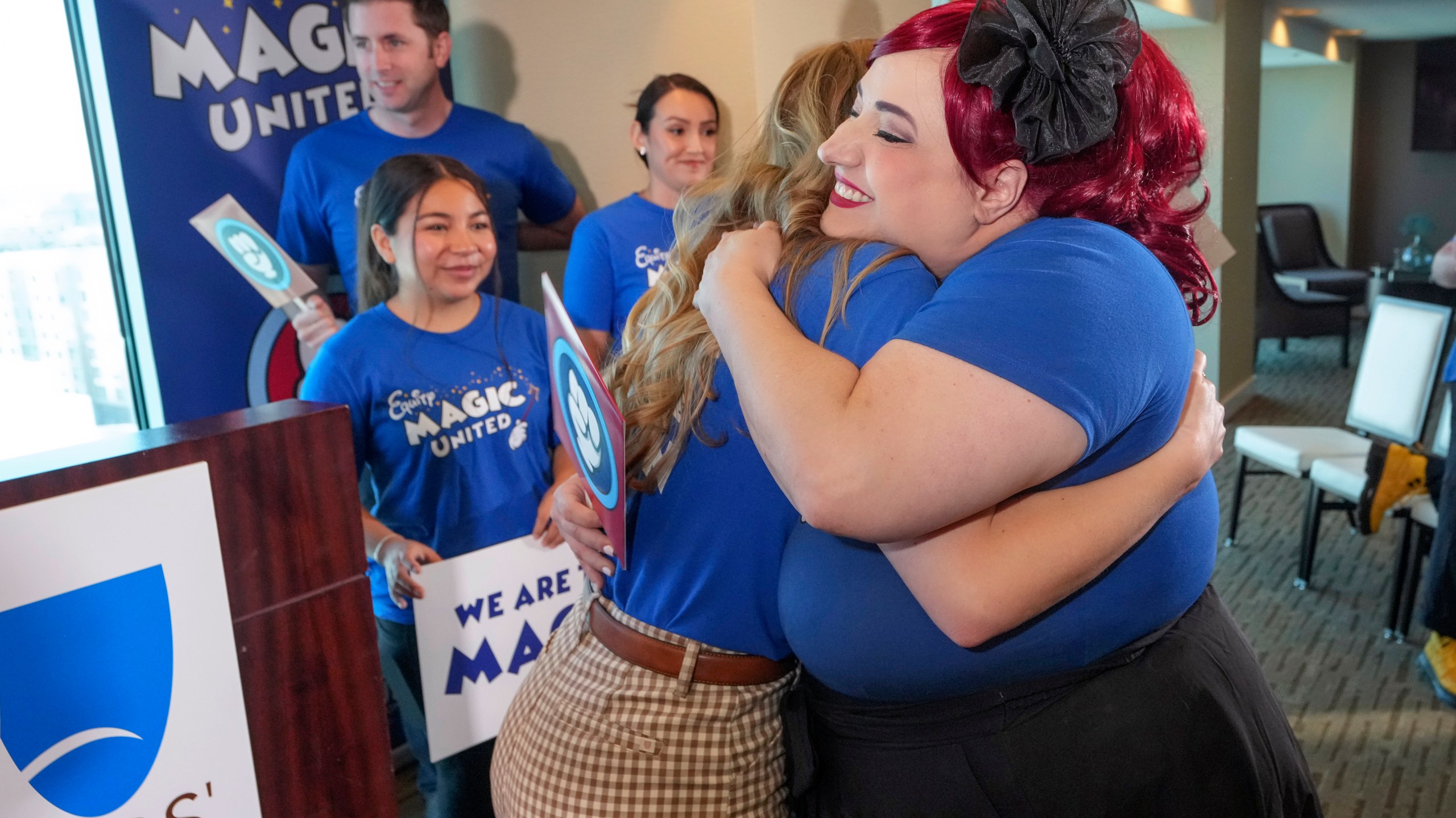 Disneyland Resort Cast Members, Courtney Griffith, left, hugs Angela Nichols after a news conference in Anaheim, Calif., Wednesday, April 17, 2024. Workers who help bring Disneyland's beloved characters to life said Wednesday they collected enough signatures to support their push for a union. (AP Photo/Damian Dovarganes)