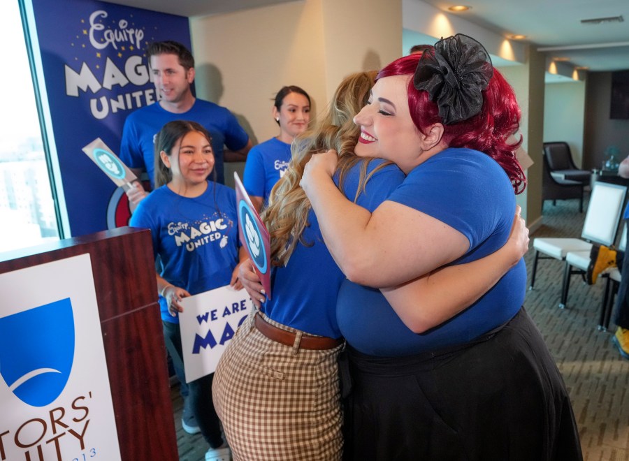 Disneyland Resort Cast Members, Courtney Griffith, left, hugs Angela Nichols after a news conference in Anaheim, Calif., Wednesday, April 17, 2024. Workers who help bring Disneyland's beloved characters to life said Wednesday they collected enough signatures to support their push for a union. (AP Photo/Damian Dovarganes)