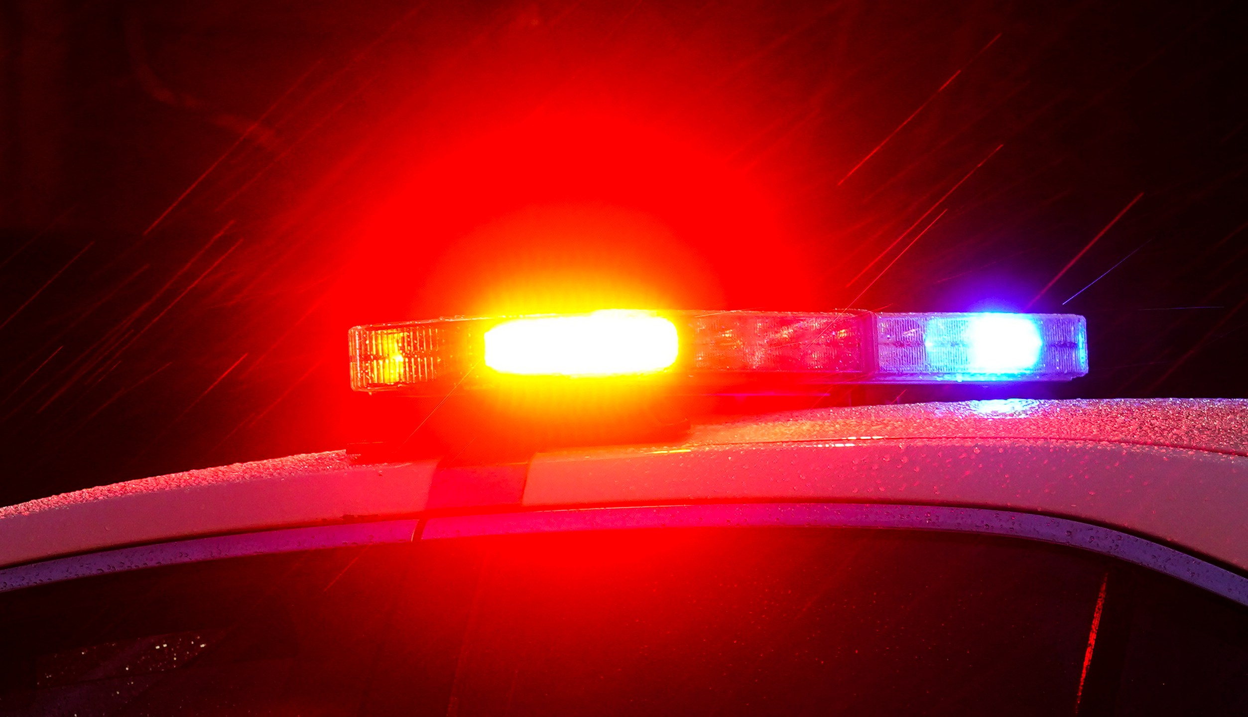 FILE - Shown is a Philadelphia police car with flashing lights in Philadelphia, Monday, Jan. 17, 2022. Police departments reported a year-over-year increase in sworn officers in 2023 for the first time since the COVID-19 pandemic began and since the 2020 police killing of George Floyd spurred nationwide protests and increased scrutiny of police, according to a survey released by the Police Executive Research Forum. (AP Photo/Matt Rourke, File)