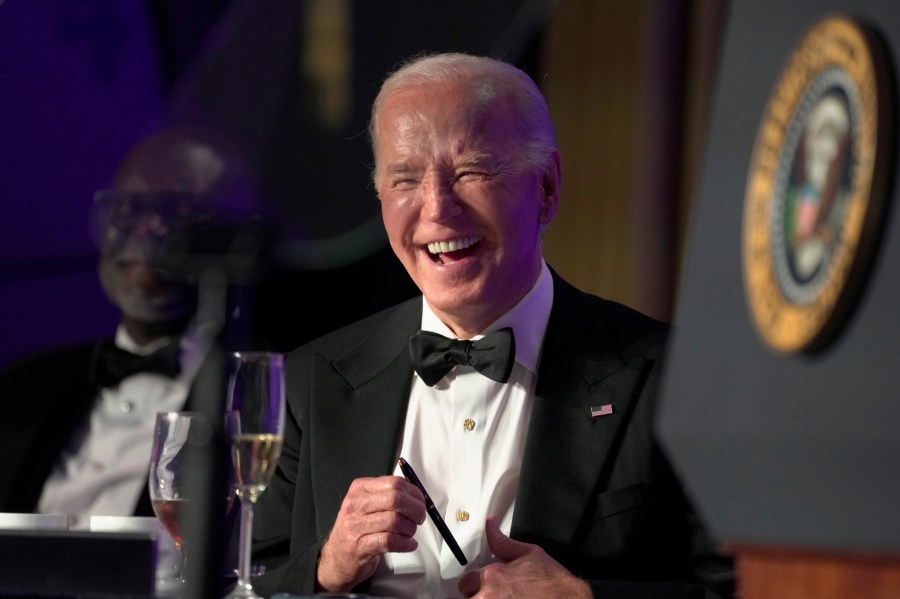 President Joe Biden laughs as host Colin Jost speaks at the White House Correspondents' Association Dinner at the Washington Hilton, Saturday, April 27, 2024, in Washington. (AP Photo/Manuel Balce Ceneta)