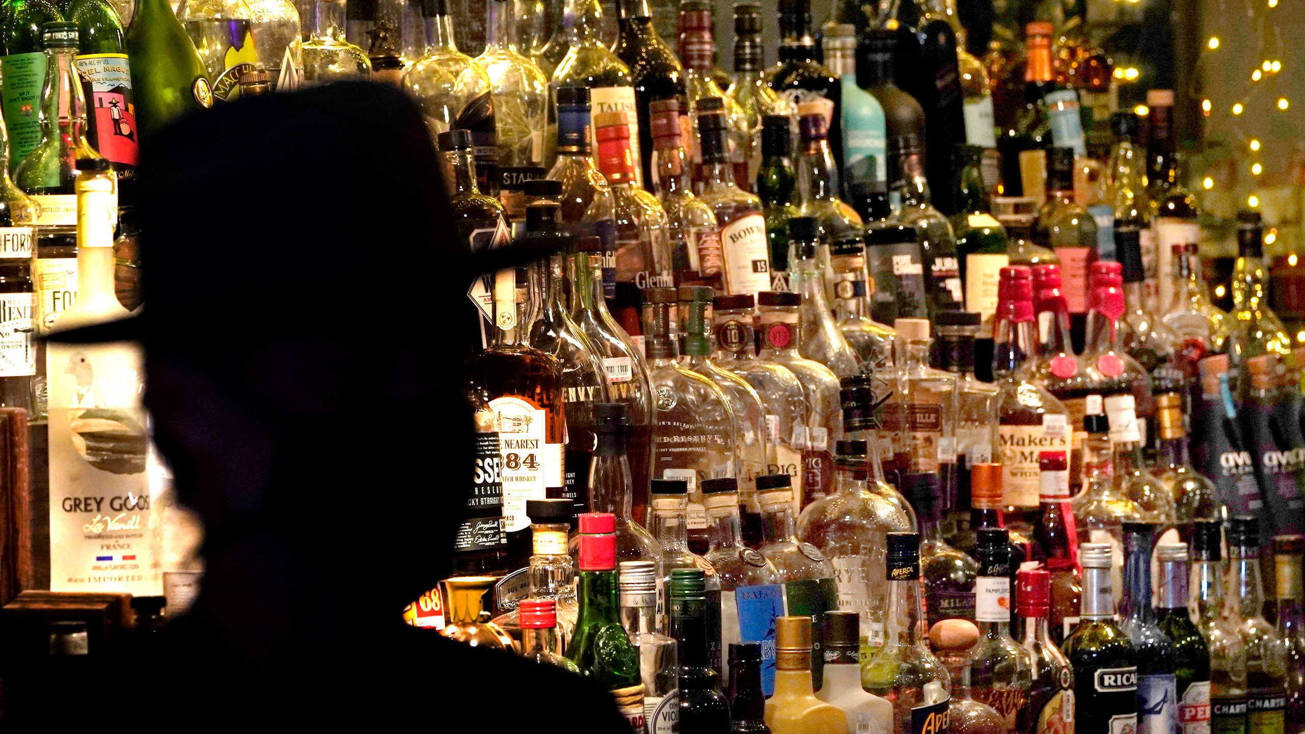 FILE - Bottles of alcohol sit on shelves at a bar in Houston on June 23, 2020. Moderate drinking was once thought to have benefits for the heart, but better research methods starting in the 2010s have thrown cold water on that. (AP Photo/David J. Phillip, File)