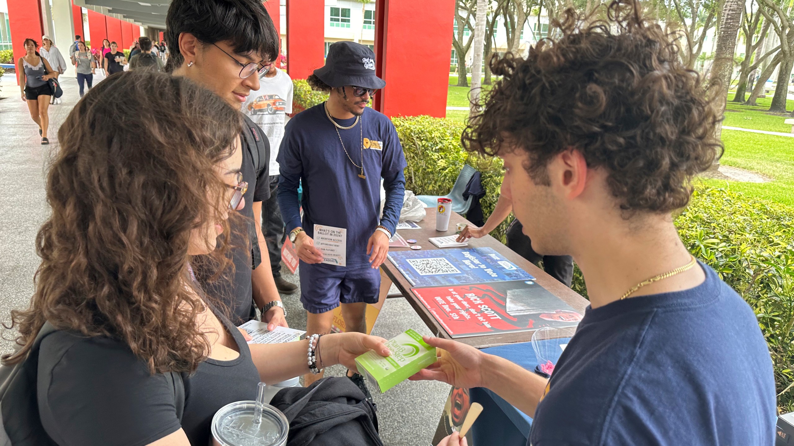 College students pass out Plan B to educate young voters at Florida Atlantic University on Thursday, April 11, 2024, in Boca Raton, Fla. Abortion and marijuana will be on Florida's November ballot, and these issues are critical issues for young voters. (AP Photo/Cody Jackson)