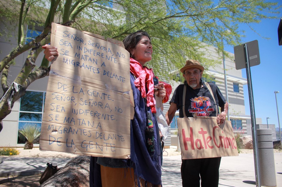 Ana Maria Vasquez Leon, left, and Magdaleno Rosa Avila protest outside the courthouse on Monday, April 29, 2024, in Nogales, Arizona. The trial of rancher George Alan Kelly in the fatal shooting of a Mexican man on his property ended last week with a deadlocked jury, and prosecutors said during a hearing Monday they would not retry him. (Angela Gervasi/Nogales International via AP)