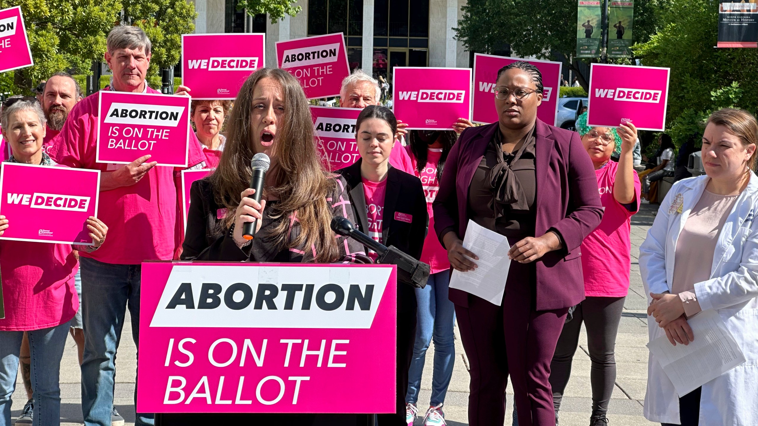 Planned Parenthood Votes South Atlantic spokesperson, Emily Thompson, announces a $10 million investment into a state voter engagement campaign at a press conference in Bicentennial Plaza in Raleigh, N.C., on Thursday, April 25, 2024. The campaign will focus on canvassing, mailers, digital ads and phone banking to block a GOP legislative supermajority and Republican governor in the 2024 election. (AP Photo/Makiya Seminera)