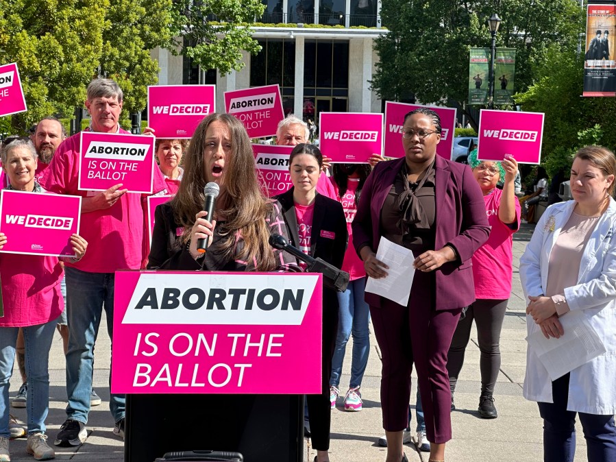 Planned Parenthood Votes South Atlantic spokesperson, Emily Thompson, announces a $10 million investment into a state voter engagement campaign at a press conference in Bicentennial Plaza in Raleigh, N.C., on Thursday, April 25, 2024. The campaign will focus on canvassing, mailers, digital ads and phone banking to block a GOP legislative supermajority and Republican governor in the 2024 election. (AP Photo/Makiya Seminera)