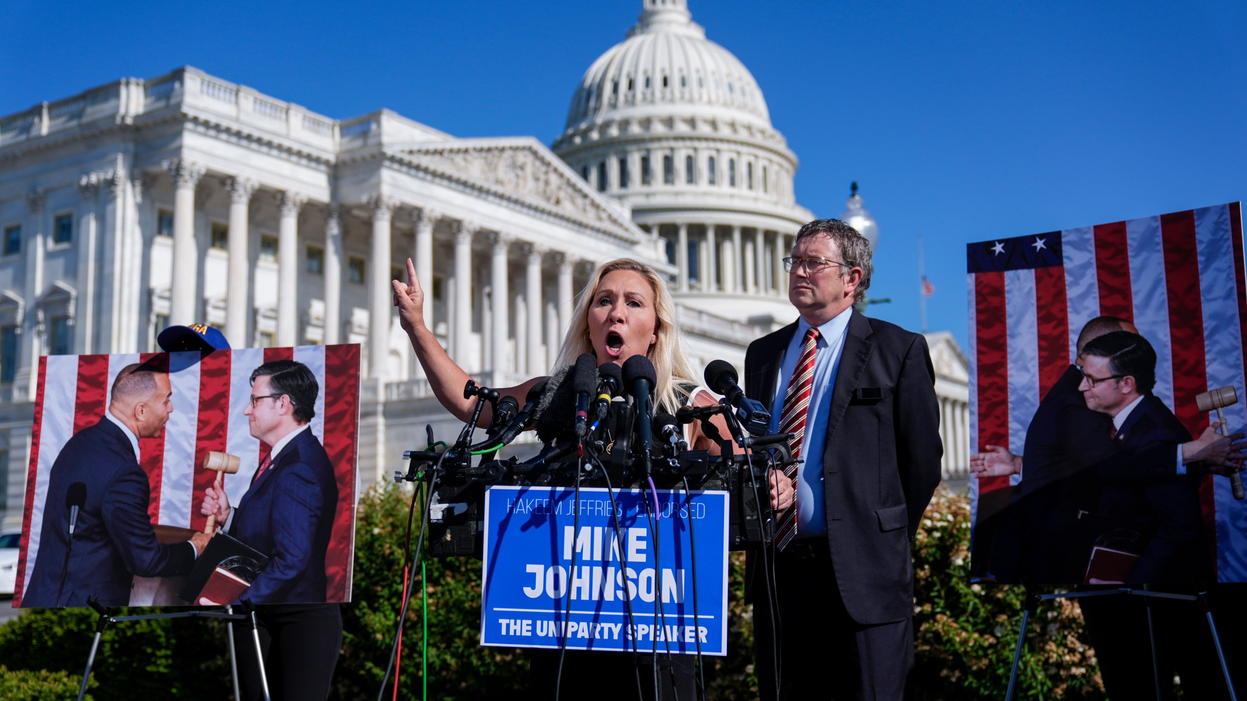 Rep. Marjorie Taylor Greene, R-Ga., joined by Rep. Thomas Massie, R-Ky., says she'll call a vote next week on ousting House Speaker Mike Johnson, R-La., during a news conference at the Capitol in Washington, Wednesday, May 1, 2024. Rep. Greene, a staunch ally of former President Donald Trump, is forcing her colleagues to choose sides after Democratic leaders announced they'd provide the votes to save the Republican speaker's job. (AP Photo/J. Scott Applewhite)