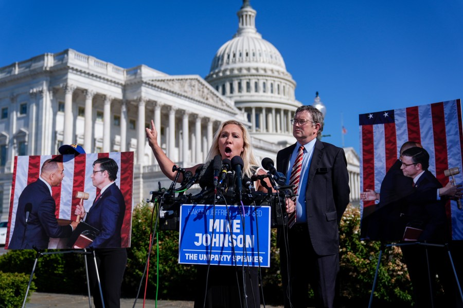 Rep. Marjorie Taylor Greene, R-Ga., joined by Rep. Thomas Massie, R-Ky., says she'll call a vote next week on ousting House Speaker Mike Johnson, R-La., during a news conference at the Capitol in Washington, Wednesday, May 1, 2024. Rep. Greene, a staunch ally of former President Donald Trump, is forcing her colleagues to choose sides after Democratic leaders announced they'd provide the votes to save the Republican speaker's job. (AP Photo/J. Scott Applewhite)