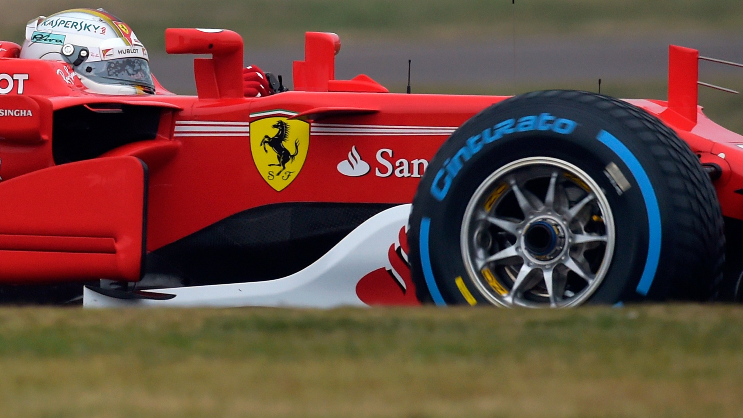 FILE - Sebastian Vettel steers the Ferrari Formula One SF70H racer at the Ferrari Fiorano private test track in Maranello, Italy, Feb. 24, 2017. Short-term rental giant Airbnb is listing 11 iconic locations, including a night at the Ferrari Museum in Maranello, in a splashy new marketing campaign. (AP Photo/Marco Vasini, File)