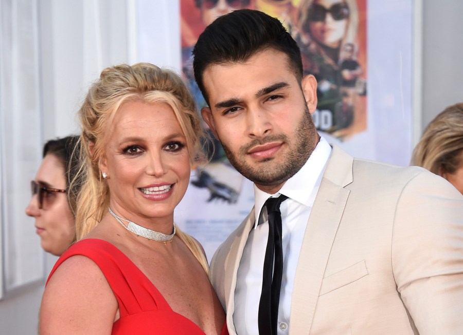 FILE - Britney Spears and Sam Asghari appear at the Los Angeles premiere of "Once Upon a Time in Hollywood" on July 22, 2019. Spears has reached a divorce settlement with her soon-to-be-ex-husband Asghari. (Photo by Jordan Strauss/Invision/AP, File)