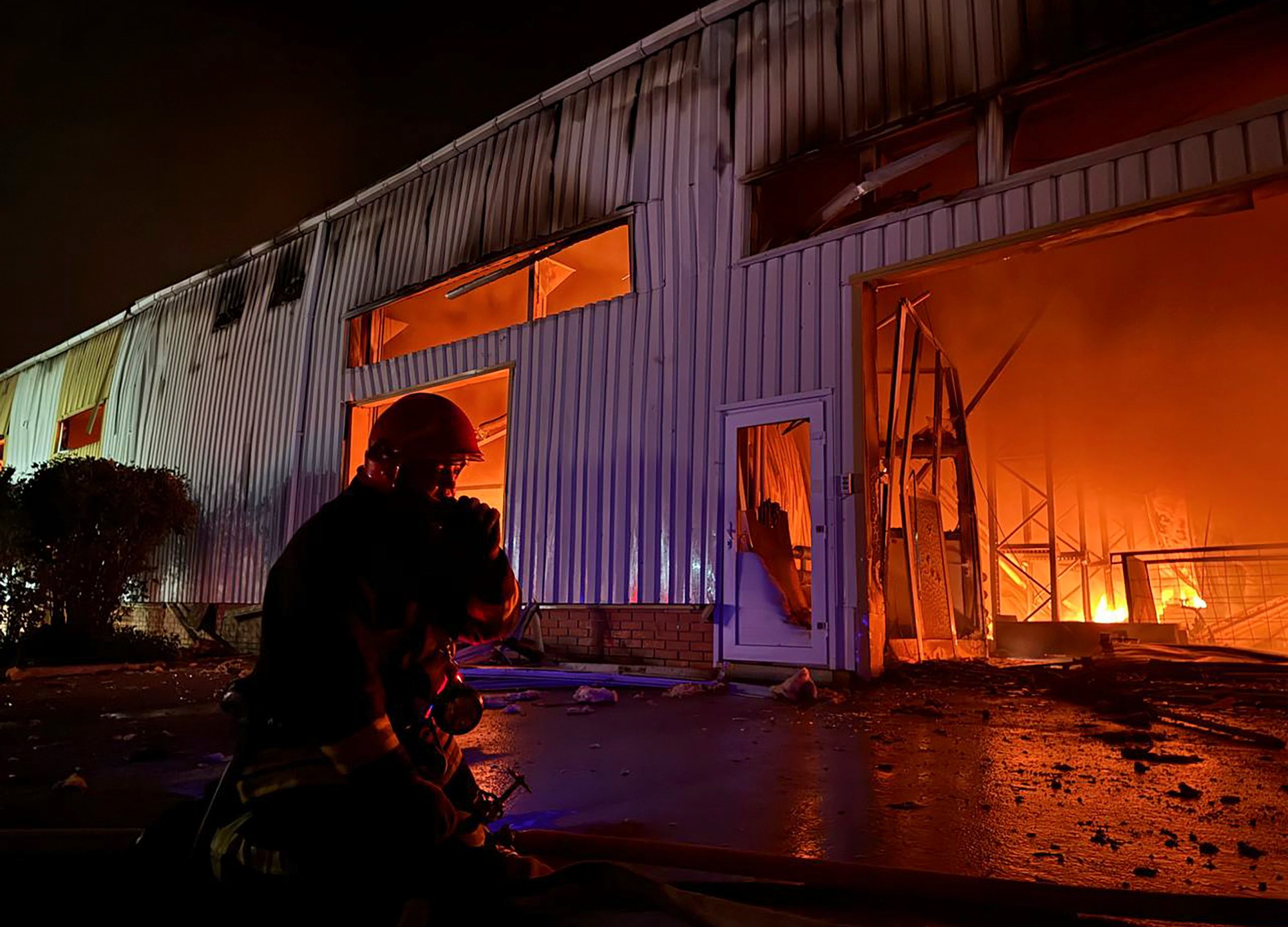 In this photo provided by the Ukrainian Emergency Service, emergency service personnel try to extinguish a fire following a Russian attack in Odesa, Ukraine, Wednesday, May 1, 2024. (Ukrainian Emergency Service via AP)