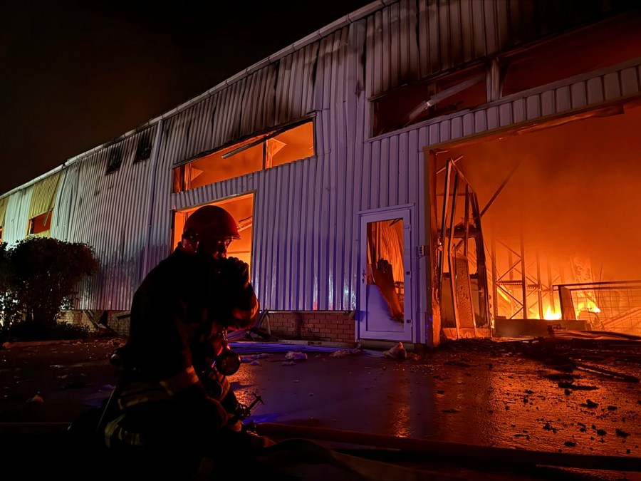 In this photo provided by the Ukrainian Emergency Service, emergency service personnel try to extinguish a fire following a Russian attack in Odesa, Ukraine, Wednesday, May 1, 2024. (Ukrainian Emergency Service via AP)