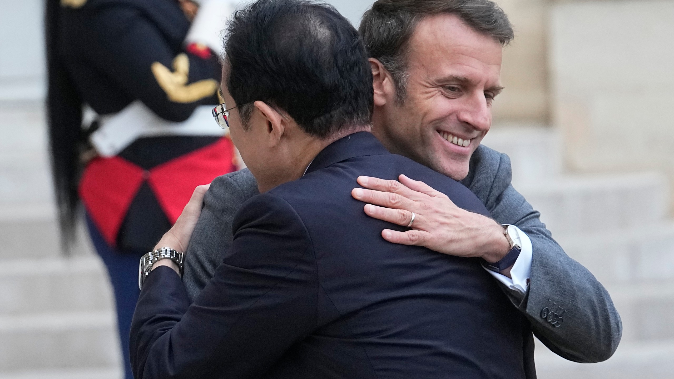 French President Emmanuel Macron, right, hugs Japanese Prime Minister Fumio Kishida before a working lunch, Thursday, May 2, 2024 at the Elysee Palace in Paris. (AP Photo/Michel Euler)