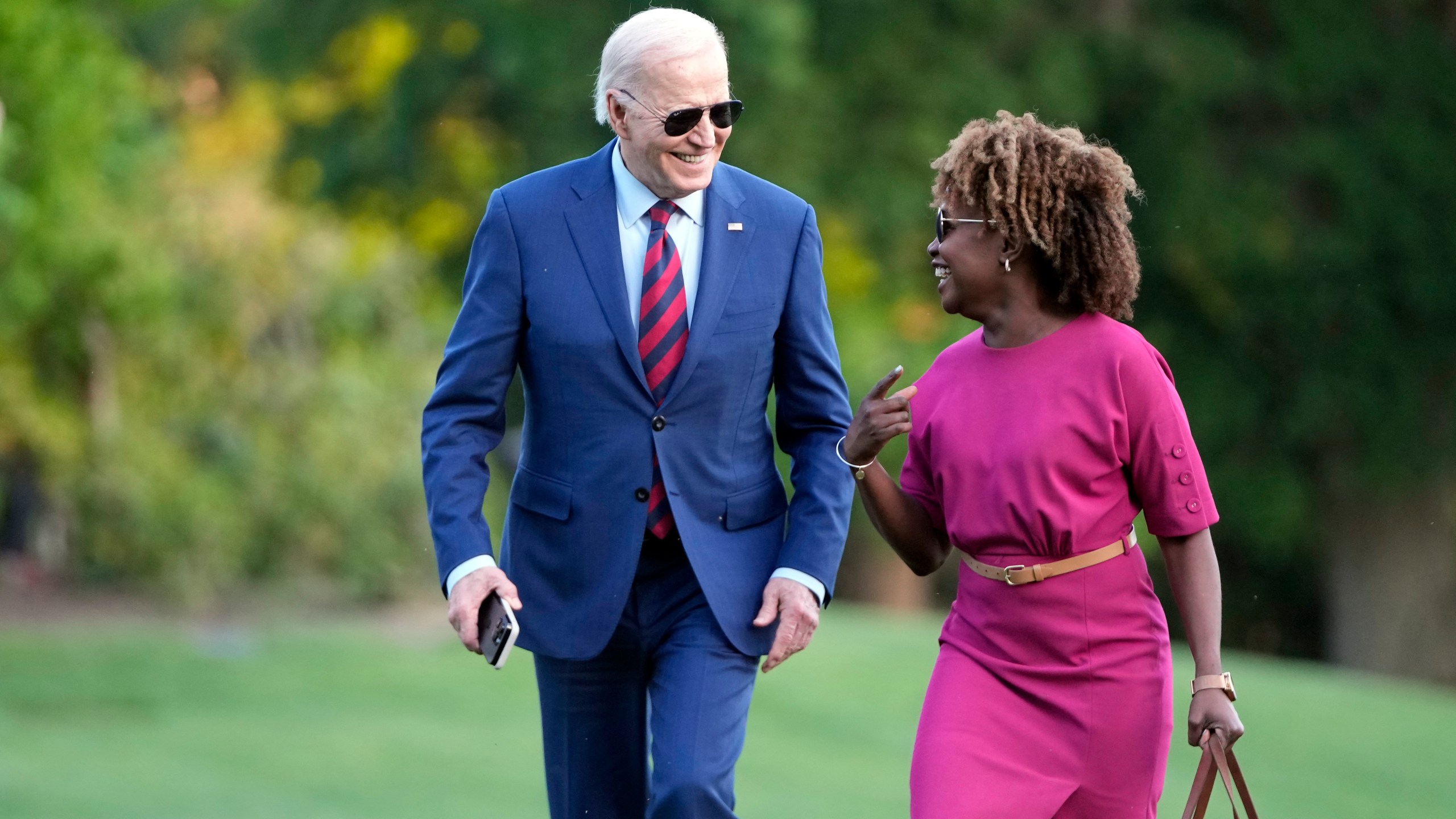 President Joe Biden walks across the South Lawn of the White House as he talks with White House press secretary Karine Jean-Pierre Thursday, May 2, 2024, in Washington, after returning from a trip to North Carolina. (AP Photo/Mark Schiefelbein)