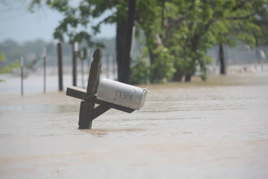 A mailbox is partially submerged on a flooded street in an unincorporated area in east Harris County near Houston on Sunday morning, May 5, 2024. The nearby San Jacinto River, overflowing due to heavy rainfall earlier this week, caused the flood waters. (AP Photo/Lekan Oyekanmi)