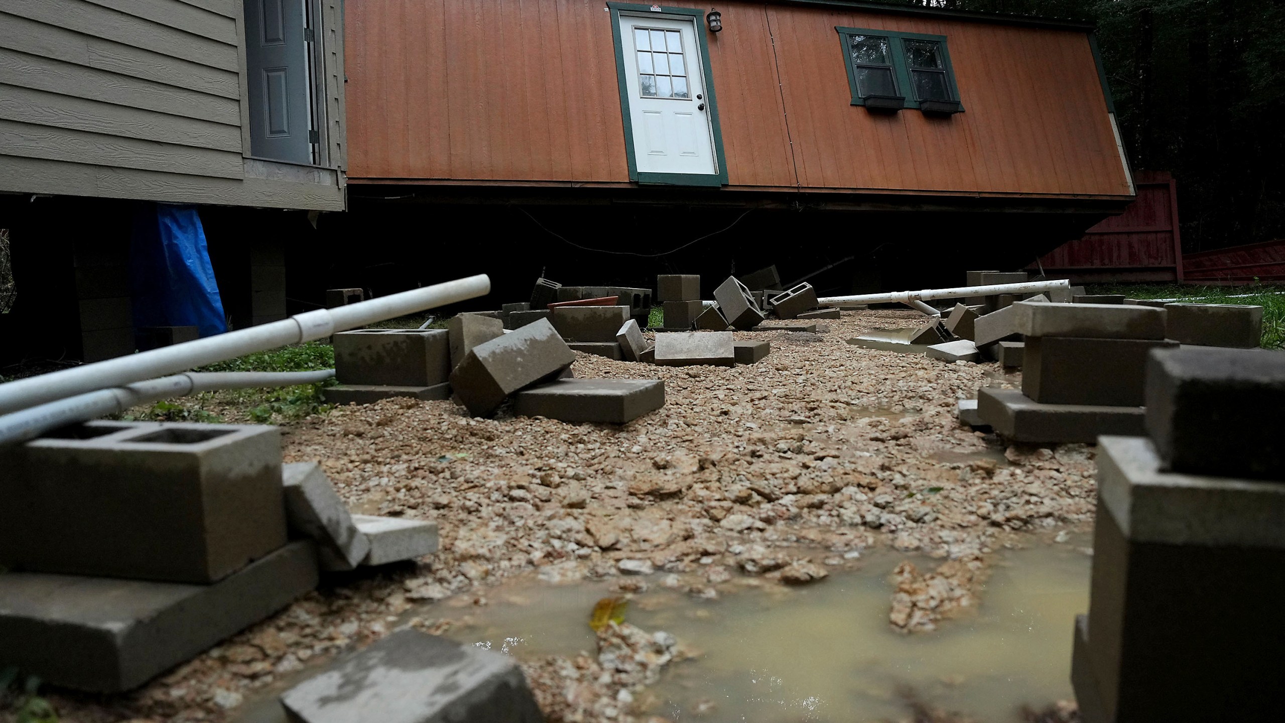 Dorothy and Earl Blevins' temporary home sits off its foundation after it was moved by flooded water and into the new home they are building on property once owned by Dorothy's mother on Sunday, May 5, 2024, in Spendora, Texas. "We've never flooded like this," said Dorothy. (Elizabeth Conley/Houston Chronicle via AP)