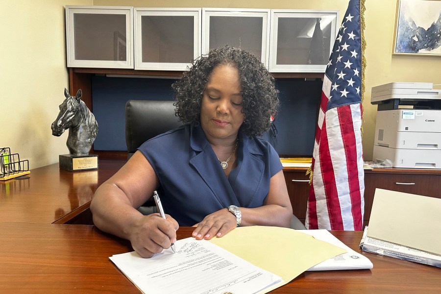 Louisiana Democratic state Rep. Delisha Boyd works at her desk at her office May 3, 2024, in New Orleans. As Boyd faces an uphill battle in Louisiana, as she attempts to advance a bill that would add cases of rape and incest as exceptions to Louisiana's near total abortion ban, the Democrat opens opening up about her mother's harrowing story and how it effected them. (AP Photo/Stephen Smith)