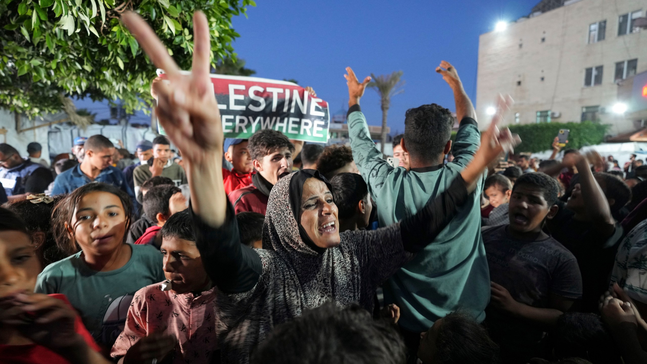 Palestinians celebrate in the streets following Hamas's announcement that it accepted a cease-fire proposal in Deir al-Balah, Gaza Strip on Monday, May 6, 2024. Despite the Hamas announcement, Israel said later Monday it would move forward with its planned offensive on Rafah, in the south of the strip. (AP Photo/Abdel Kareem Hana)