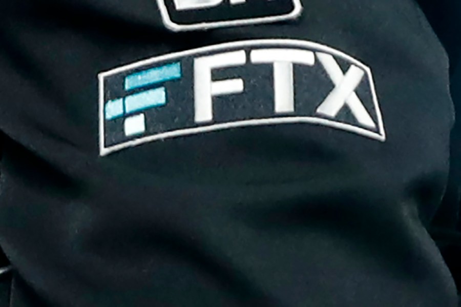 FILE - The FTX logo appears on home plate umpire Jansen Visconti's jacket at a baseball game with the Minnesota Twins on Sept. 27, 2022, in Minneapolis. Failed cryptocurrency exchange FTX says that nearly all of its customers will receive the money back that they are owed, and some will get more than that, according to its reorganization plan. FTX said in a court filing Tuesday, May 7, 2024 that it owes about $11.2 billion to its creditors. (AP Photo/Bruce Kluckhohn, File)