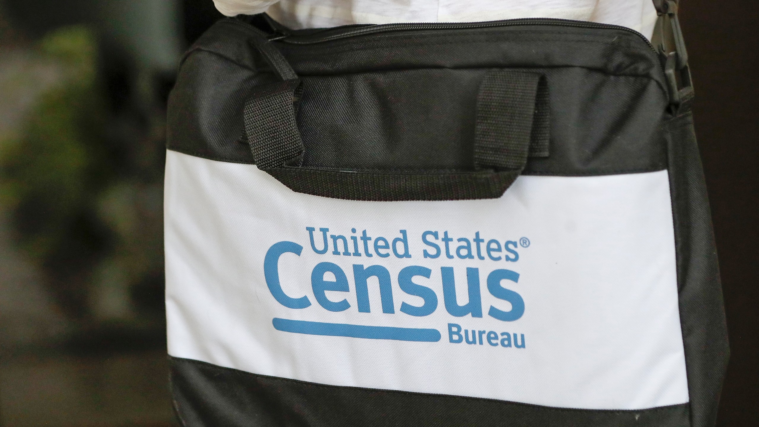 FILE - The briefcase of a census taker is seen as she knocks on the door of a residence, Aug. 11, 2020, in Winter Park, Fla. Republican lawmakers are pushing measures that would require a citizenship question on the once-a-decade census and exclude people who aren’t citizens from the head count which determines political power in the U.S. (AP Photo/John Raoux, File)