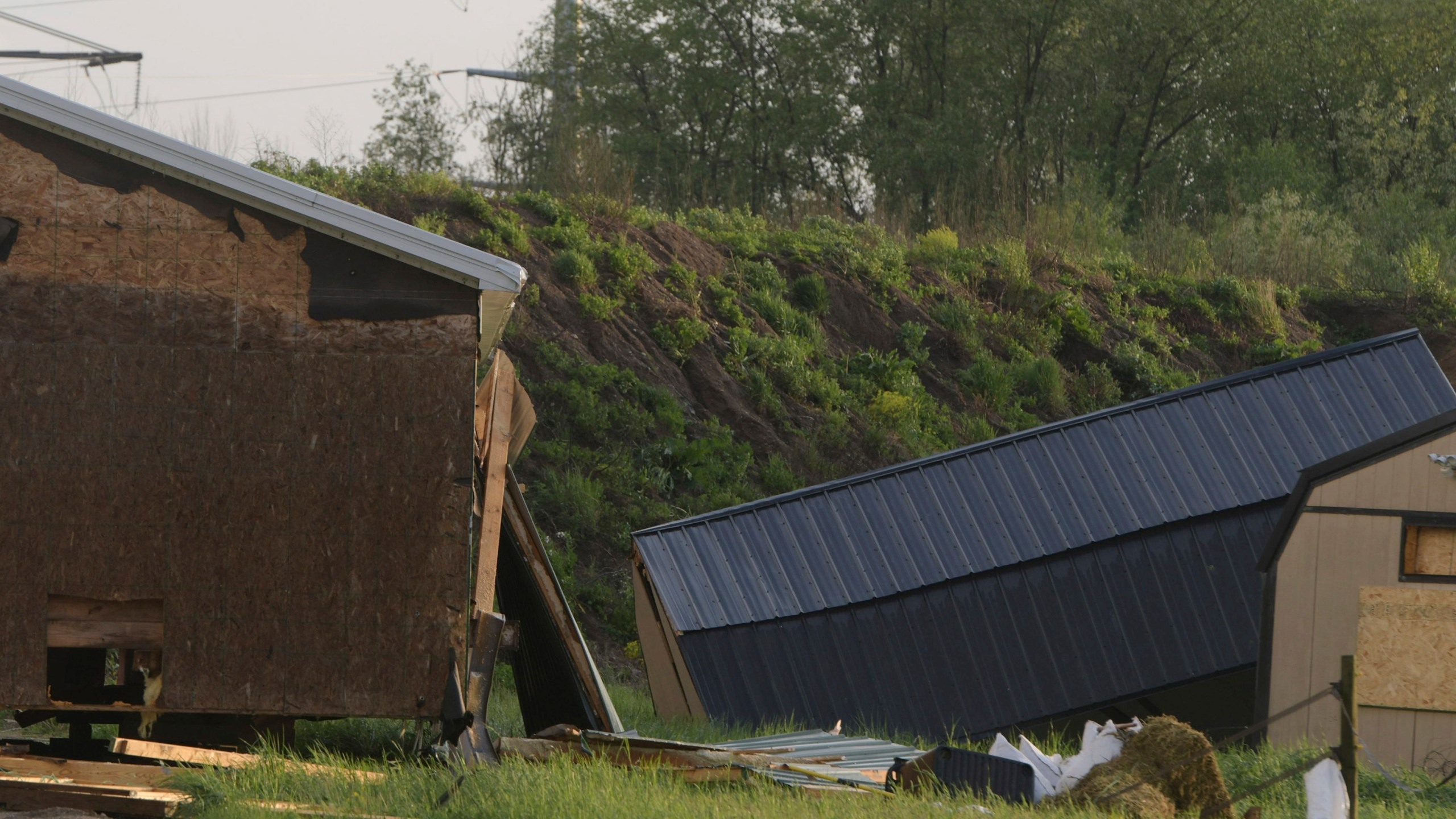 Debris litters the ground near damaged buildings after a tornado swept through the area of the Pavilion Estates mobile home park, in Kalamazoo, Mich., Tuesday, May 7, 2024. Multiple injuries were reported at the park. ( J. Scott Park/Jackson Citizen Patriot via AP)