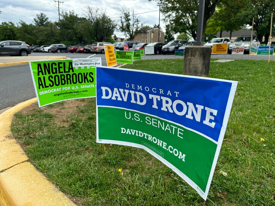 Signs are pictured outside an early voting center on Thursday, May 9, 2024, in Rockville, Md. President Joe Biden and former President Donald Trump look to pad their delegate totals in Maryland Tuesday, May 14. Maryland voters will also decide contested primaries in a Senate race that has further complicated Democratic efforts to keep control of the narrowly divided chamber this fall. The leading Democratic primary candidates are Rep. David Trone and Prince George's County Executive Angela Alsobrooks. (AP Photo/Robert Yoon)