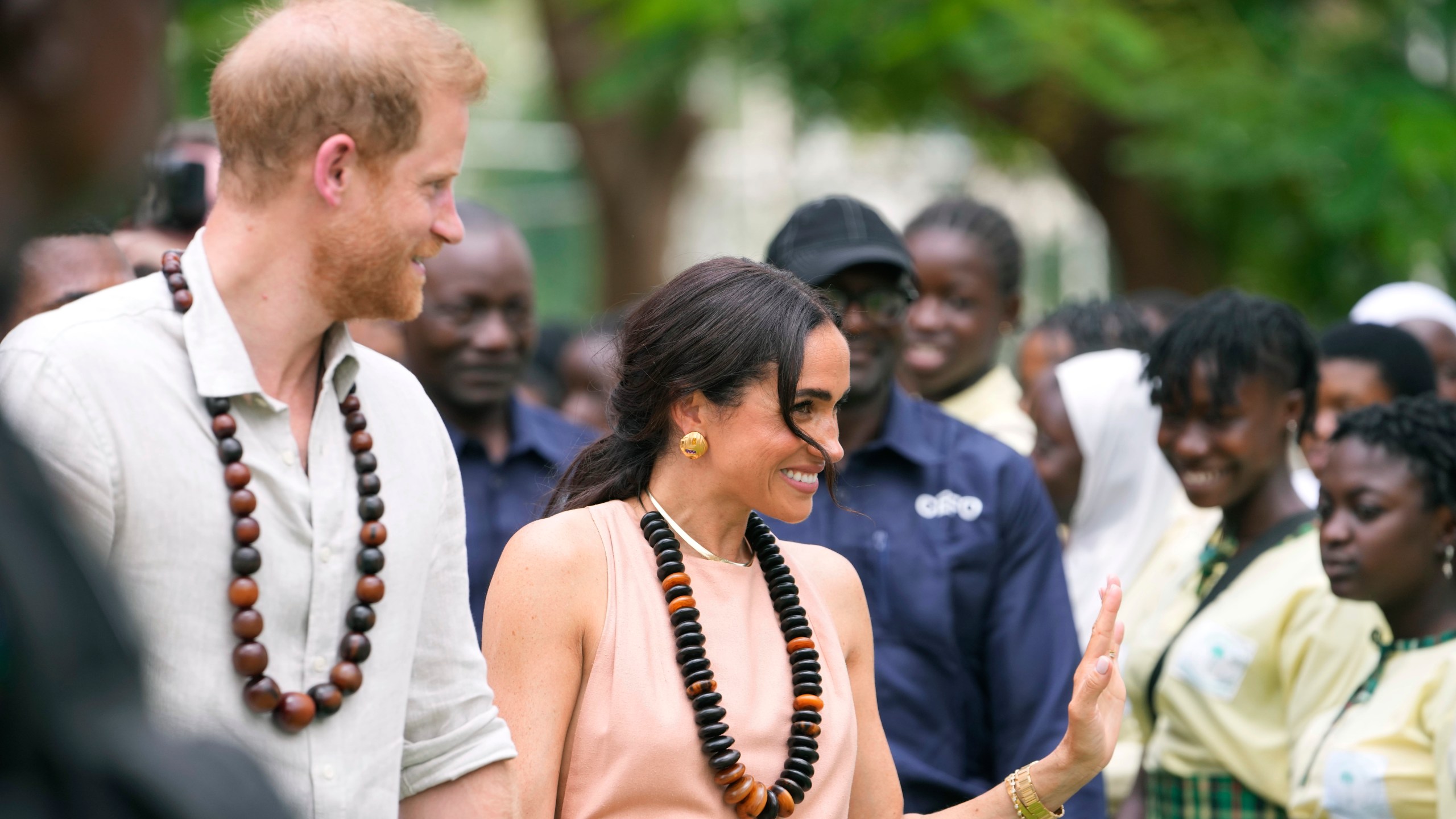 Prince Harry and Meghan visit children at the Lights Academy in Abuja, Nigeria, Friday, May 10, 2024. Prince Harry and his wife Meghan have arrived in Nigeria to champion the Invictus Games, which he founded to aid the rehabilitation of wounded and sick servicemembers and veterans. (AP Photo/Sunday Alamba)