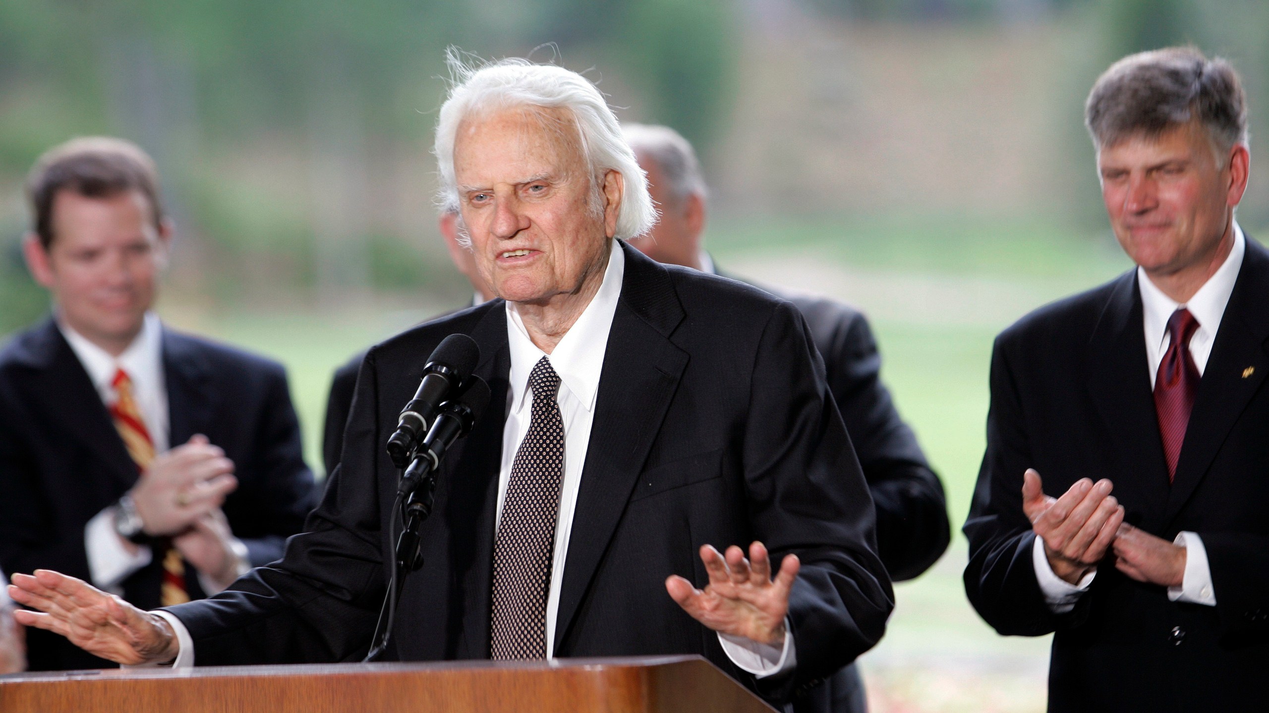 Billy Graham speaks as his son Franklin Graham, right, listens during a dedication ceremony for the Billy Graham Library, May 31, 2007 in Charlotte, N.C.. A statue of the late Rev. Billy Graham set to stand inside the U.S. Capitol to represent North Carolina will be unveiled next week in a ceremony. (AP Photo/Gerry Broome)