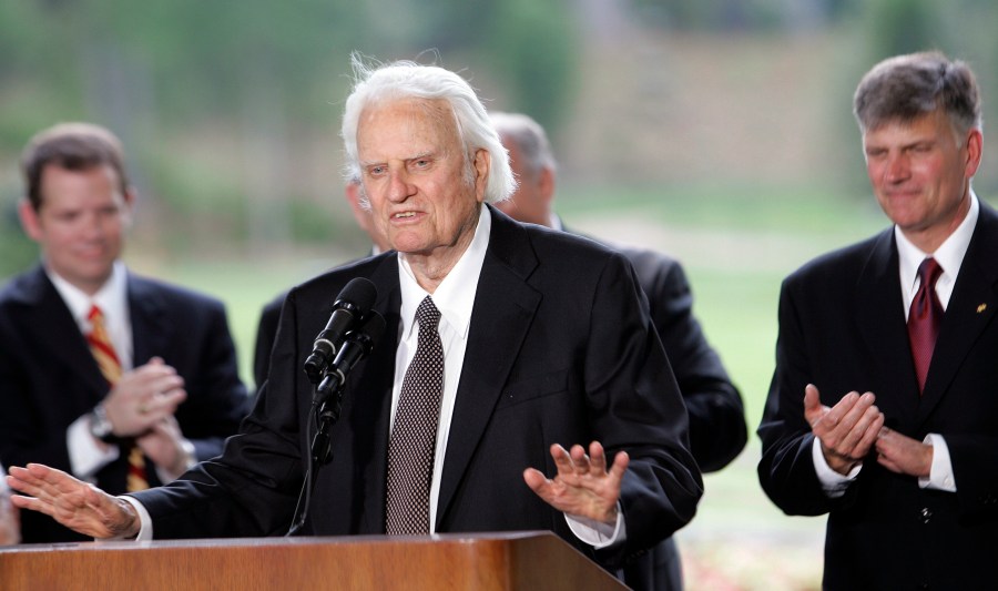 Billy Graham speaks as his son Franklin Graham, right, listens during a dedication ceremony for the Billy Graham Library, May 31, 2007 in Charlotte, N.C.. A statue of the late Rev. Billy Graham set to stand inside the U.S. Capitol to represent North Carolina will be unveiled next week in a ceremony. (AP Photo/Gerry Broome)