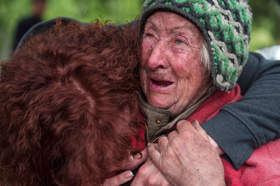 Tetiana, 82, cries with her daughter as she is evacuated from Vovchansk, Ukraine, Saturday, May 11, 2024. Her husband was killed in their house after a Russian airstrike on the city. (AP Photo/Evgeniy Maloletka)