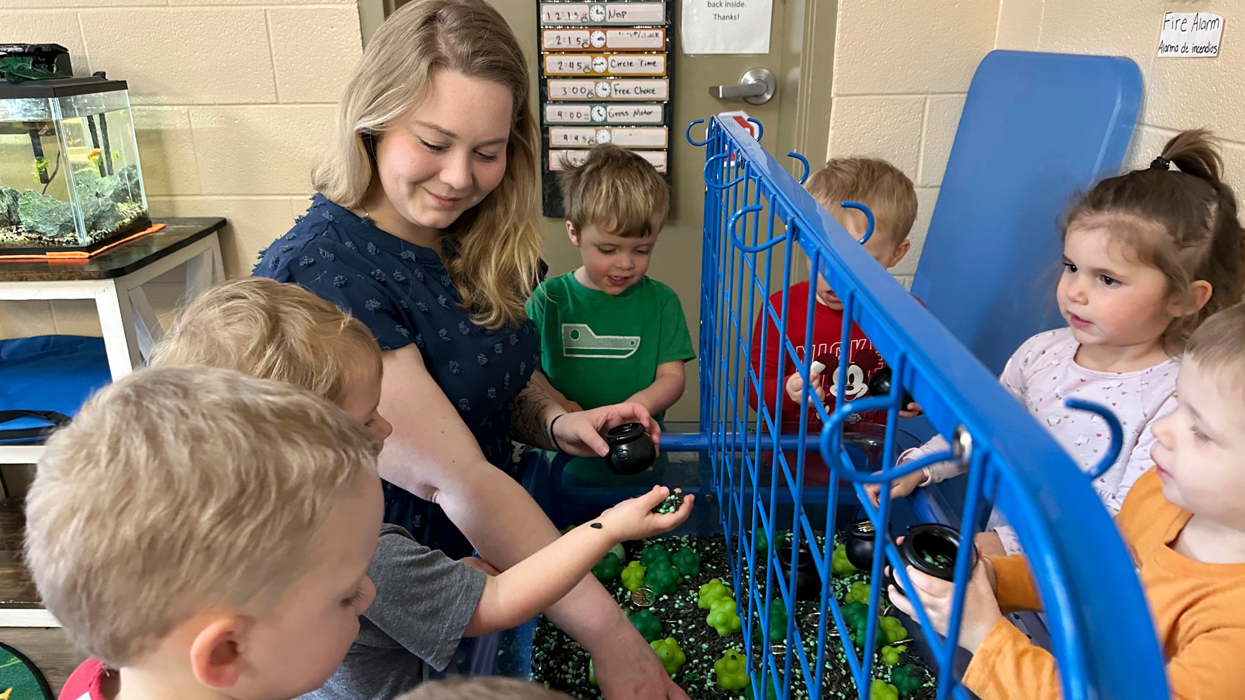 Rylee Monn plays with her class at a child care center in Lexington, Ky., Wednesday, March 13, 2024. Monn, who has two children at the center where she works, is taking advantage of a state program that offers free or reduced cost child care to child care workers. Monn says the program saves her family hundreds of dollars a week. (AP Photo/Dylan Lovan)