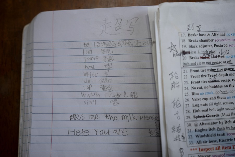 A notebook and Commercial Driving License study notes belonging to Chinese migrant Li Kai, aka Khaled, an ethnic Hui Muslim, are seen in his apartment in Flushing, New York, Friday, May 3, 2024. Li Kai came to the U.S. with his wife and two sons seeking religious freedom and a better life. The daily struggle to find work for Chinese immigrants living illegally in New York is a far cry from the picture Donald Trump and other Republicans have sought to paint about them. Asian advocacy organizations say they're concerned the exaggerated rhetoric could fuel further harassment against Asians in the U.S. (AP Photo/Serkan Gurbuz)