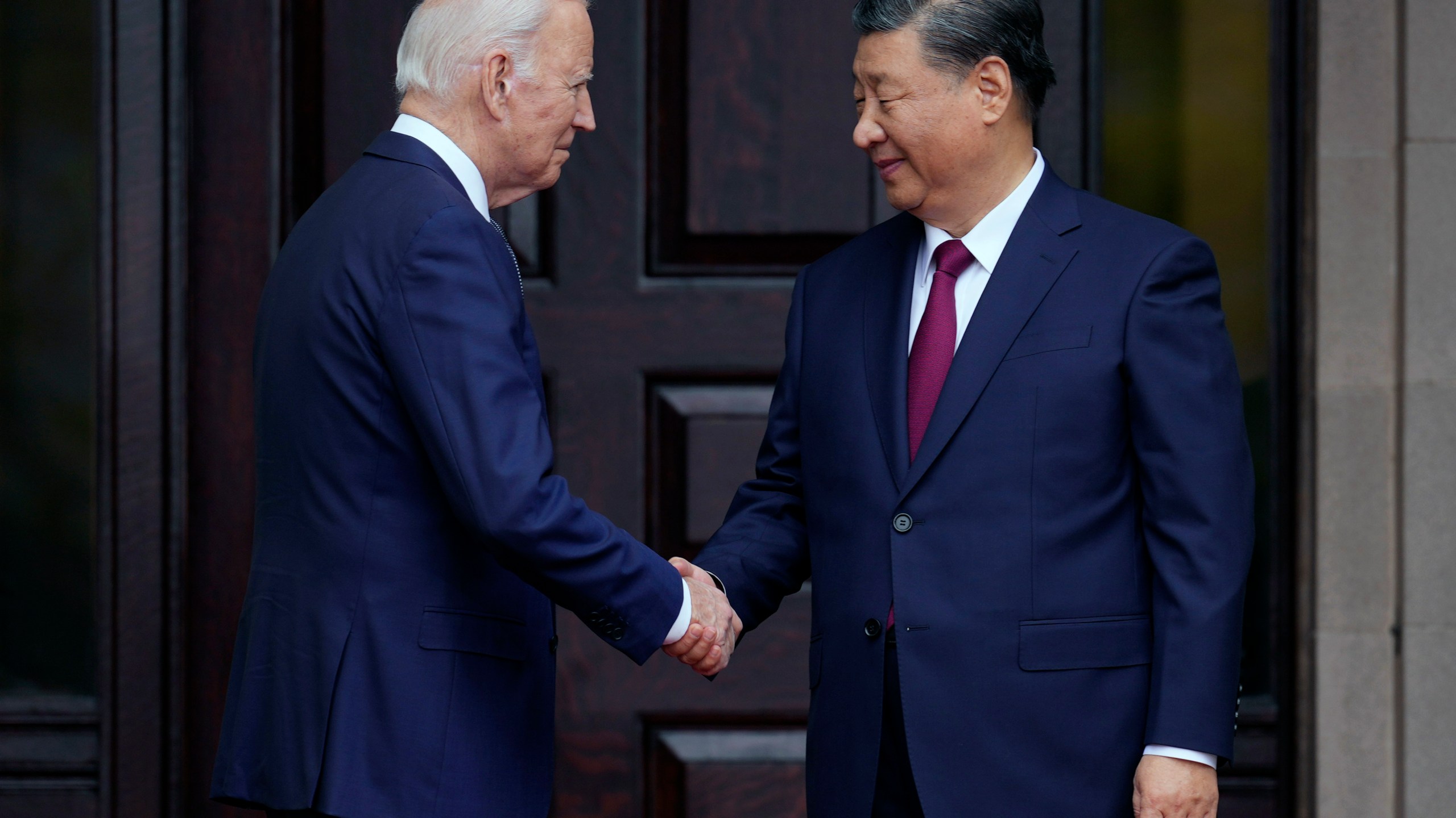 FILE - President Joe Biden, left, greets China's President President Xi Jinping, right, in Woodside, USA, Nov. 15, 2023. High-level envoys from the United States and China are set to meet in Geneva for talks about artificial intelligence including the risks of the technology and ways to set shared standards to manage it. The meeting Tuesday is billed as an opening exchange of views in an inter-governmental dialogue on AI agreed during a meeting between U.S. President Joe Biden and Chinese President Xi Jinping in San Francisco. (Doug Mills/The New York Times via AP, Pool, File)