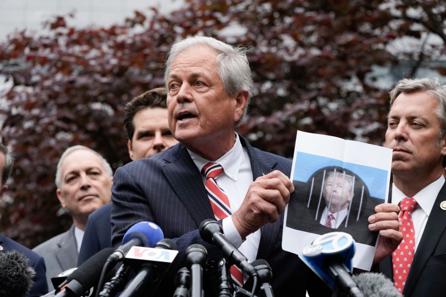 Rep. Ralph Norman, R-S.C., holds a photo of Former President Donald Trump as he speaks during a news conference at near Manhattan Criminal Court Thursday, May 16, 2024, in New York. Trump is accused of falsifying business records to cover up a sex scandal during the 2016 presidential campaign. (AP Photo/Frank Franklin II)