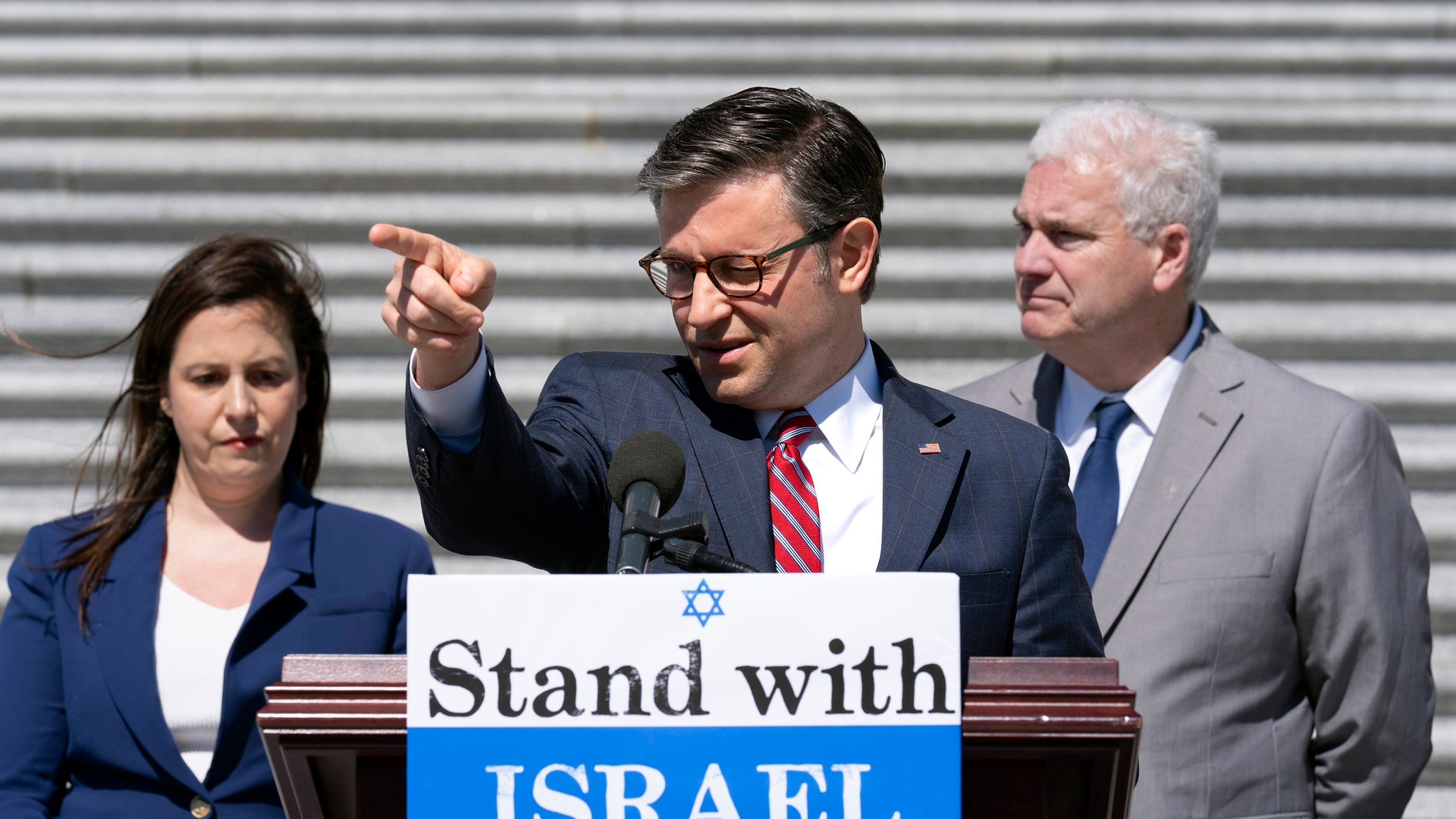 Speaker of the House Mike Johnson, R-La., center, flanked by GOP Conference Chair Elise Stefanik, R-N.Y., left, and Majority Whip Tom Emmer, R-Minn., speak to reporters about President Joe Biden pausing a shipment of bombs to Israel, at the Capitol in Washington, Thursday, May 16, 2024. (AP Photo/J. Scott Applewhite)