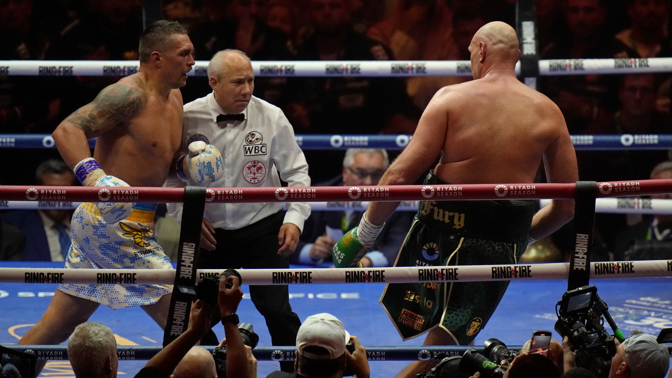 Ukraine's Oleksandr Usyk, left, pursues Britain's Tyson Fury during their undisputed heavyweight world championship boxing fight at the Kingdom Arena in Riyadh, Saudi Arabia, Sunday, May 19, 2024. (AP Photo/Francisco Seco)